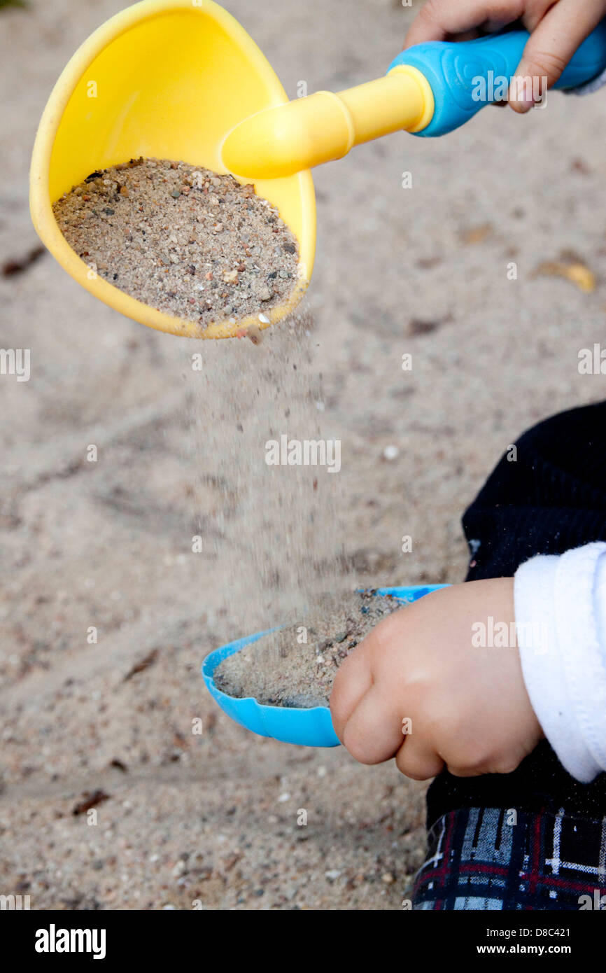 Toddler playing in sandpit Stock Photo