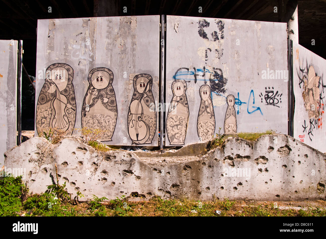 Graffiti and war damaged pockmarked wall in Mostar in Bosnia Herzegovina Stock Photo