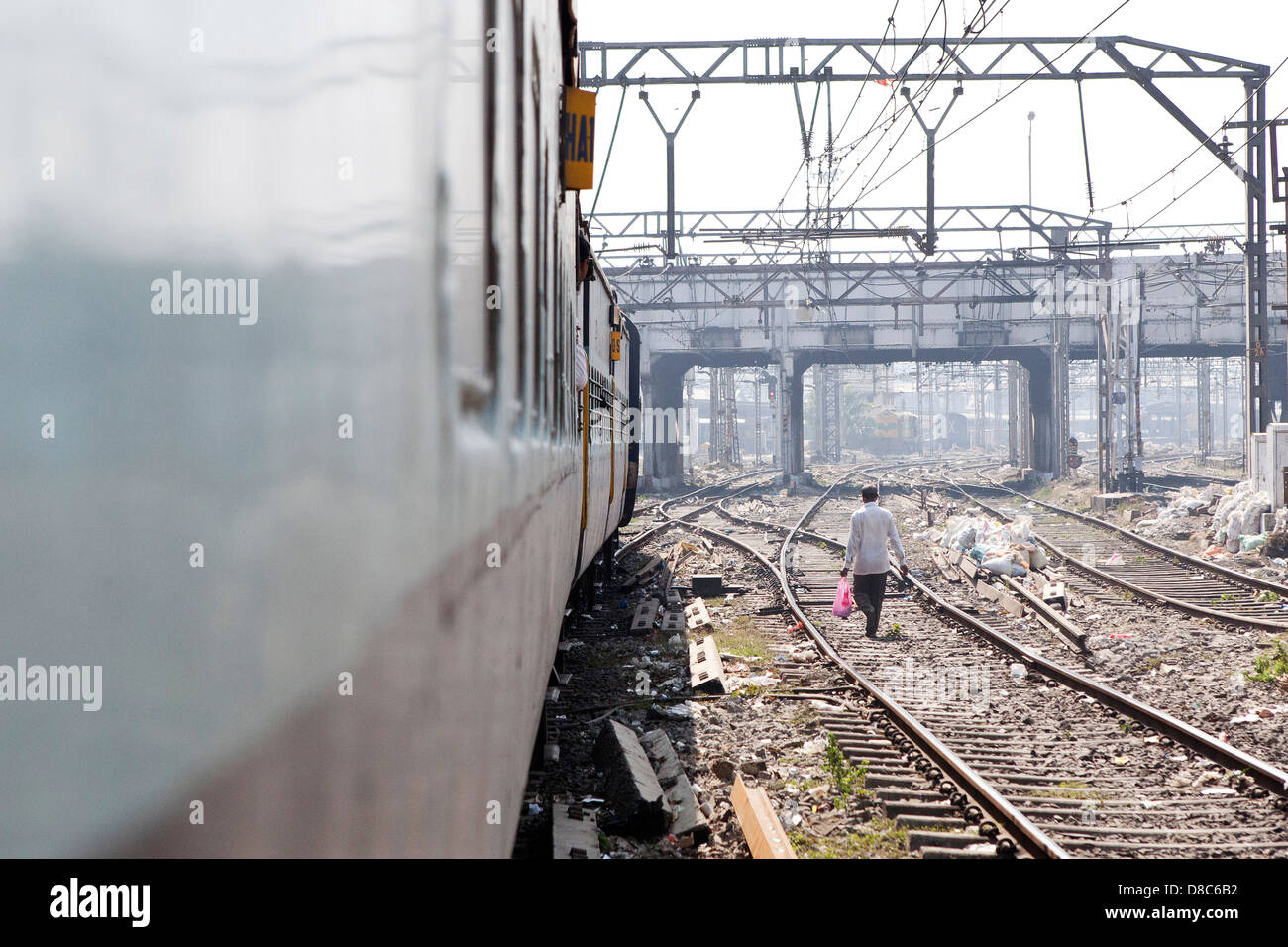 A man walking on a train track in India Stock Photo Alamy