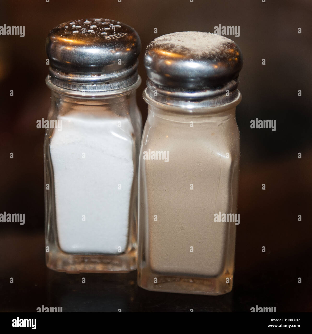 Salt and pepper in glass condiments Stock Photo