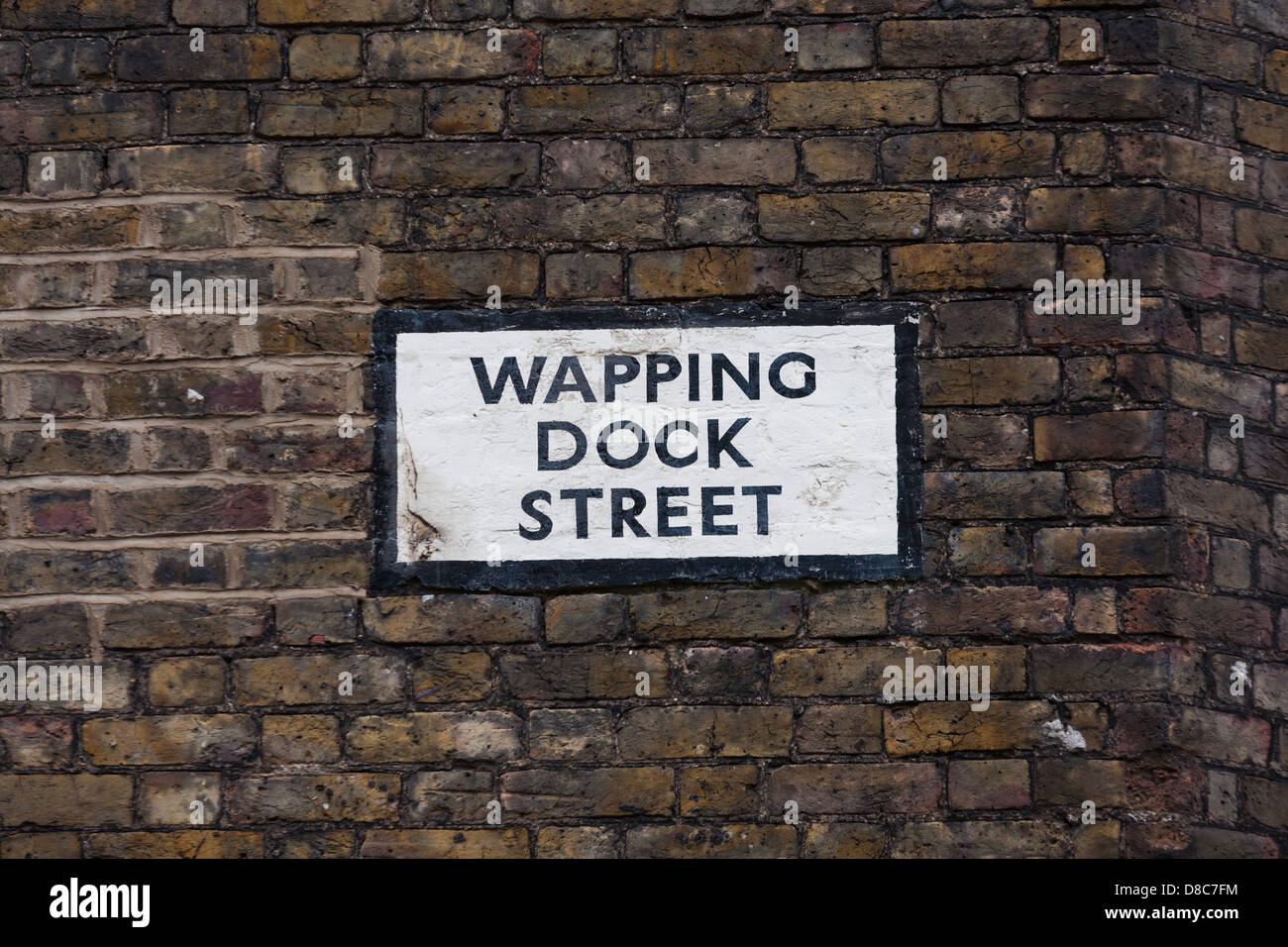 Old street sign on brick wall in Wapping Dock Street, east London. Stock Photo