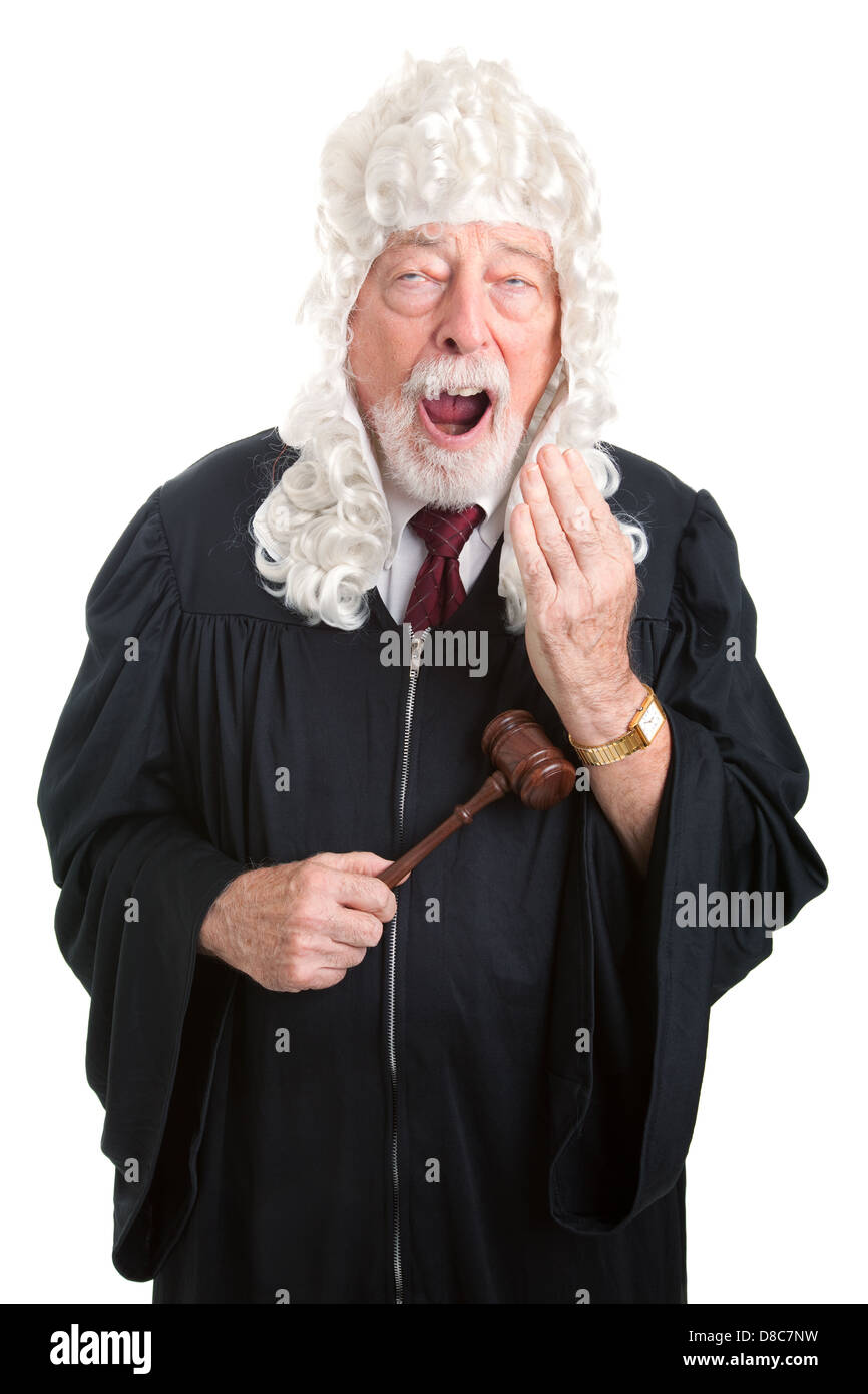 Britiish style judge wearing a wig, bored and yawning. Isolated.  Stock Photo