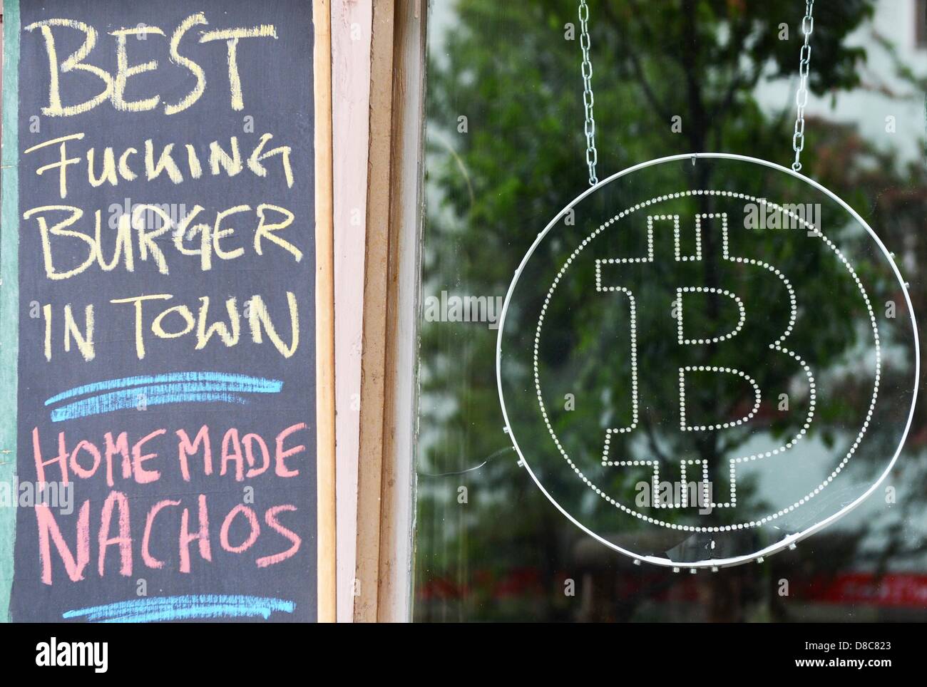 The logo of the new virtual currency Bitcoin hangs in the window of