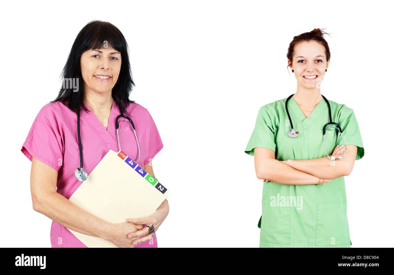 Friendly female doctors or nurses in pink and green scrubs isolated on white. Stock Photo