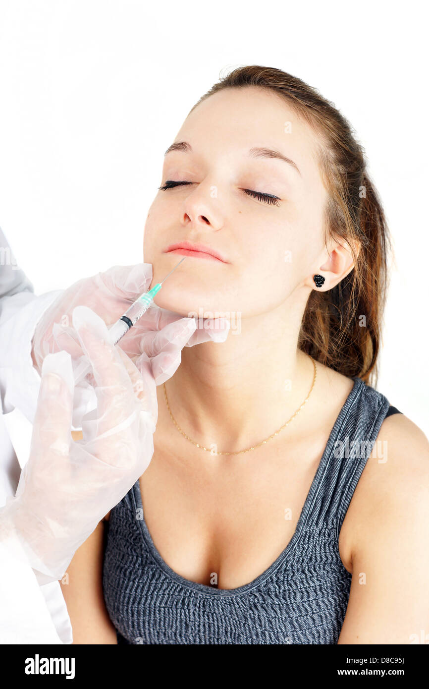 Beautiful young woman getting lip injection, botox or collagen Stock Photo
