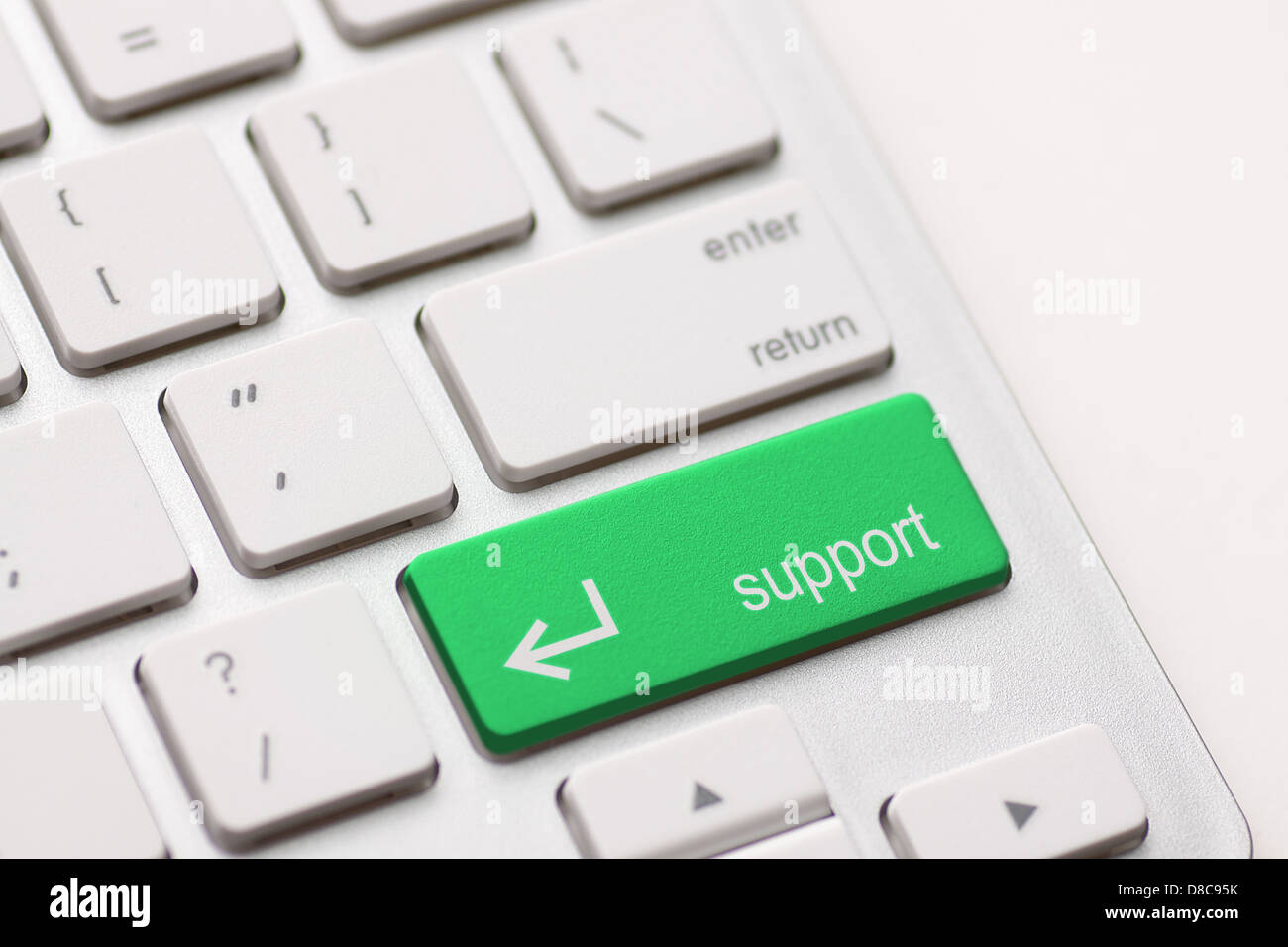 A computers support key on white keyboard Stock Photo