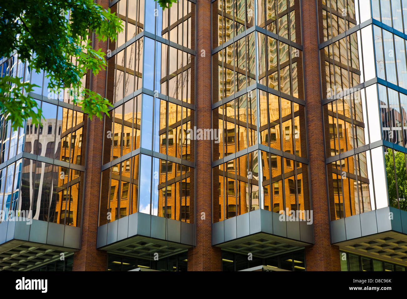 Reflections in bronze glass of a building on lower Burrard Street, Vancouver, Canada Stock Photo