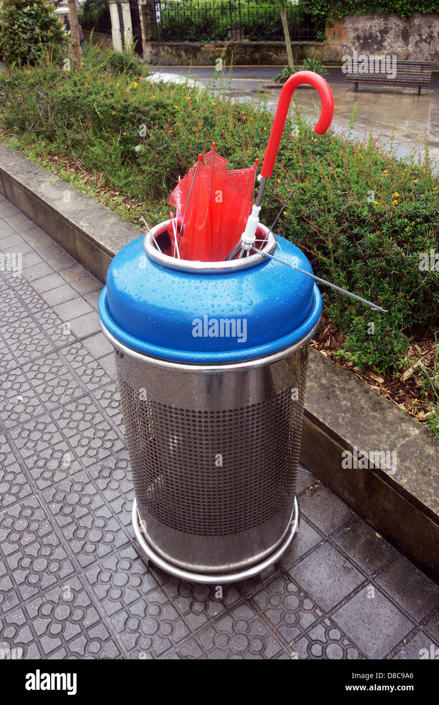 umbrella broken in garbage bin after rain and wind Stock Photo