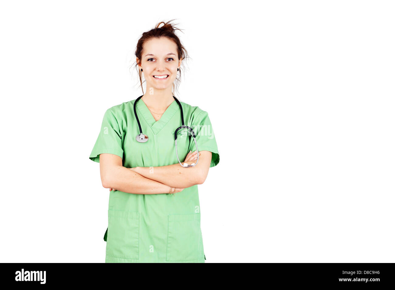 Young nurse or female doctor student in green scrubs smiling Stock Photo