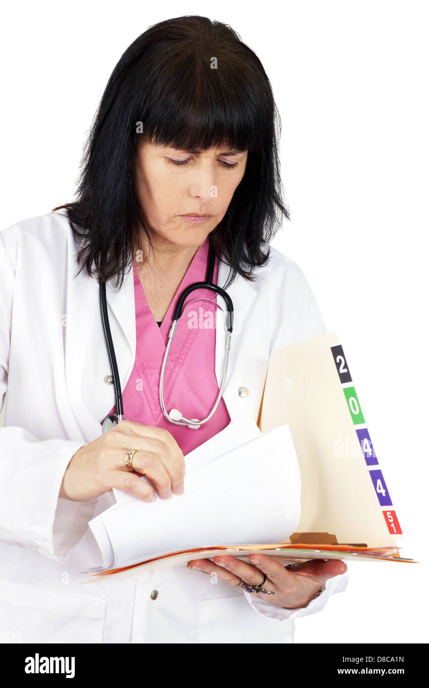Doctor looking at medical file Stock Photo