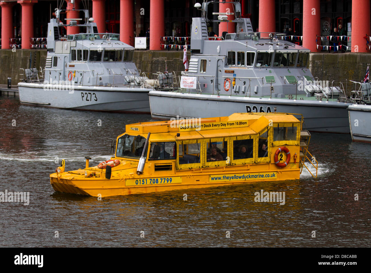 DUKW (colloquially known as Duck) is a six-wheel-drive amphibious modification of the 2+1⁄2-ton CCKW trucks in Liverpool, UK 24th May, 2013. Liverpool's iconic Yellow Duckmarine and Royal Navy Patrol Boats in Albert Dock at the 70th anniversary of the Battle of the Atlantic (BOA 70)  commemoration and events centred around Liverpool. The Battle of the Atlantic was the longest continuous military campaign in World War 2, at its height from mid-1940 through to the end of 1943. Stock Photo