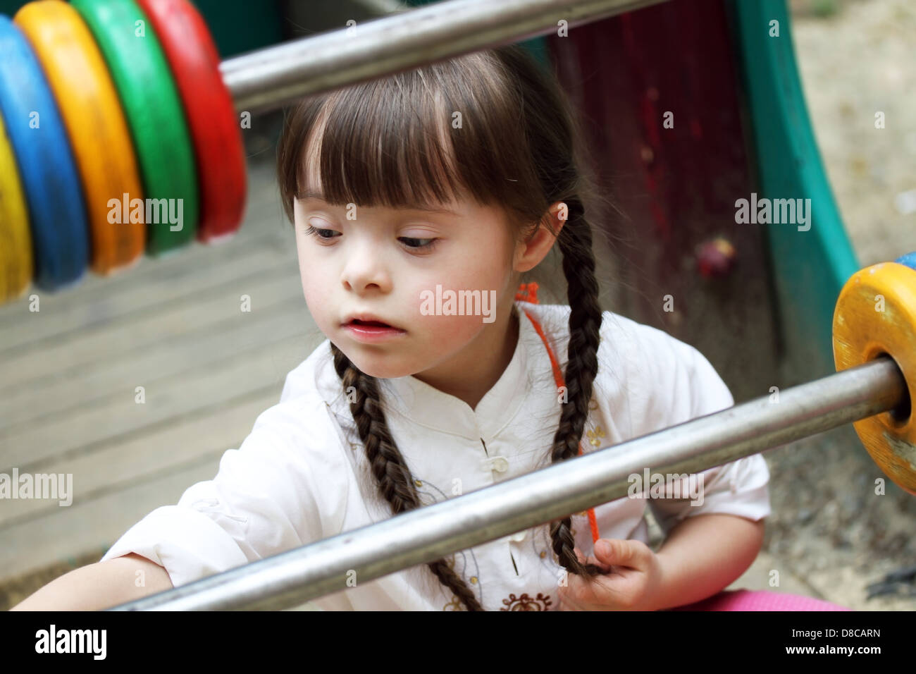 Portrait of beautiful young girl on the playground Stock Photo - Alamy