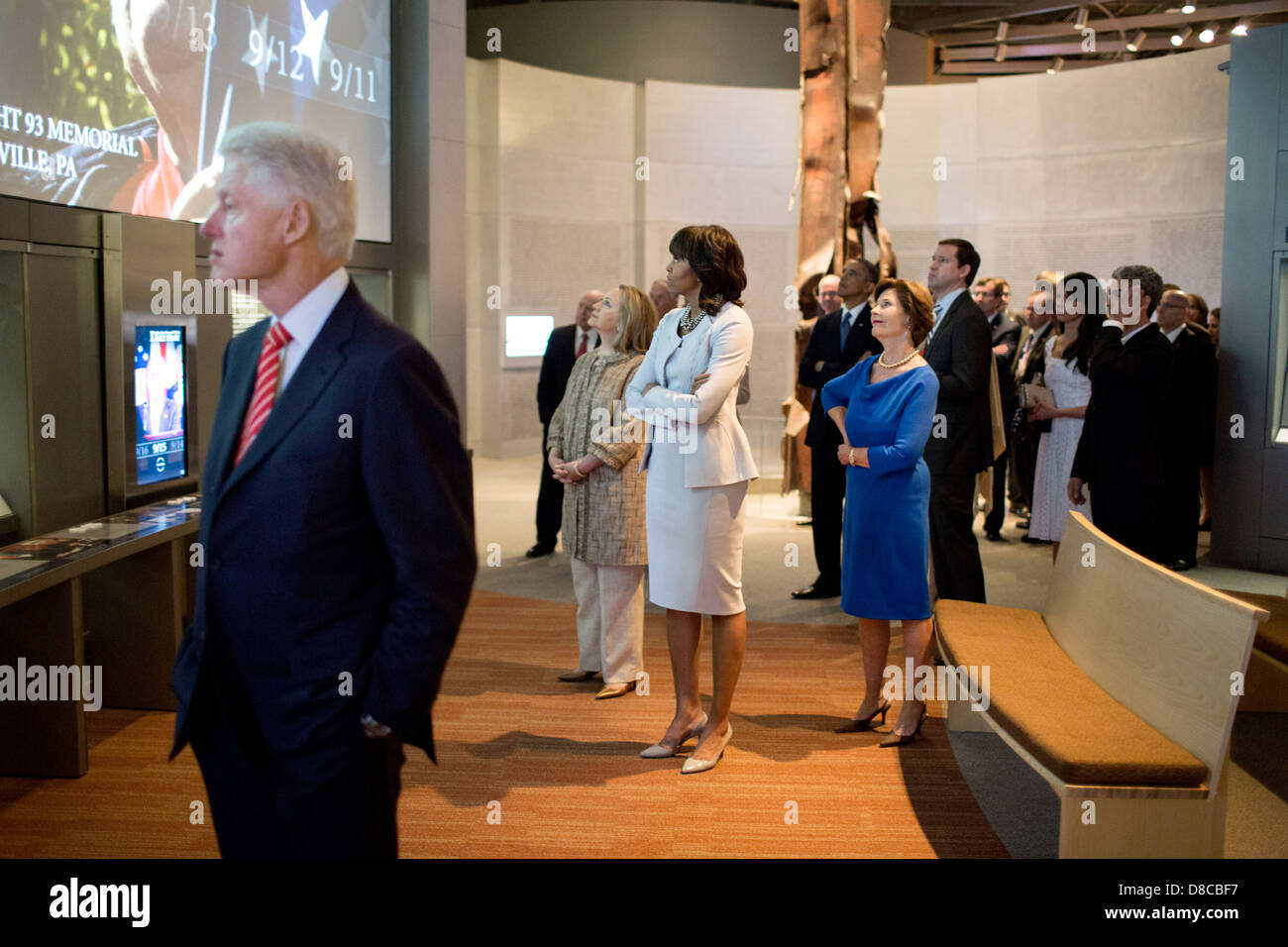 US First Lady Michelle Obama along with former First Ladies Laura Bush and Hillary Rodham Clinton look at a 9/11 exhibit while touring the George W. Bush Presidential Library and Museum on the campus of Southern Methodist University April 25, 2013 in Dallas, Texas. Former President Bill Clinton is seen in the foreground. Stock Photo