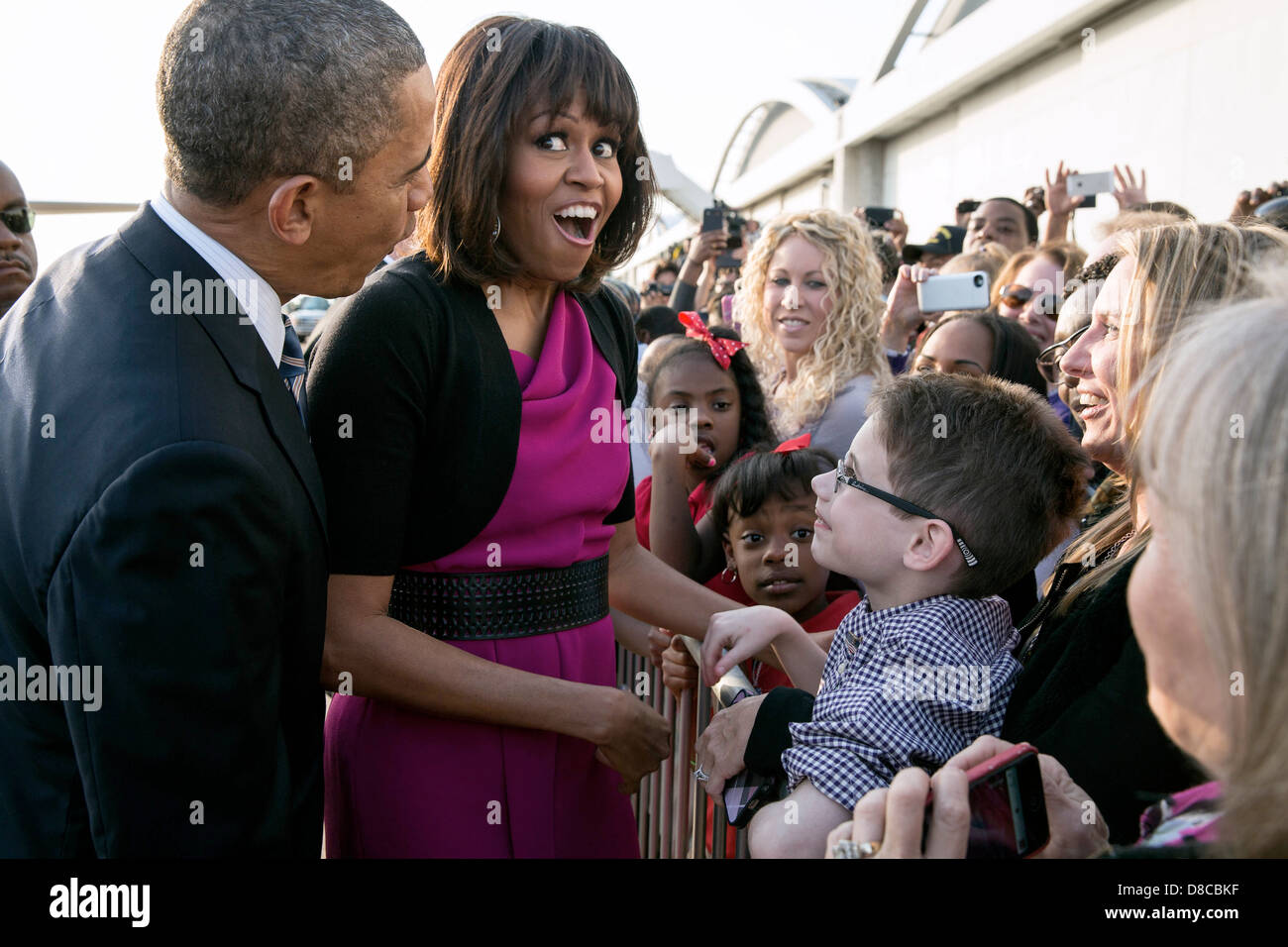 US First Lady Michelle Obama reacts after President Barack Obama quieted a baby along a ropeline at Love Field Airport April 24, 2013 in Dallas, Texas. Stock Photo