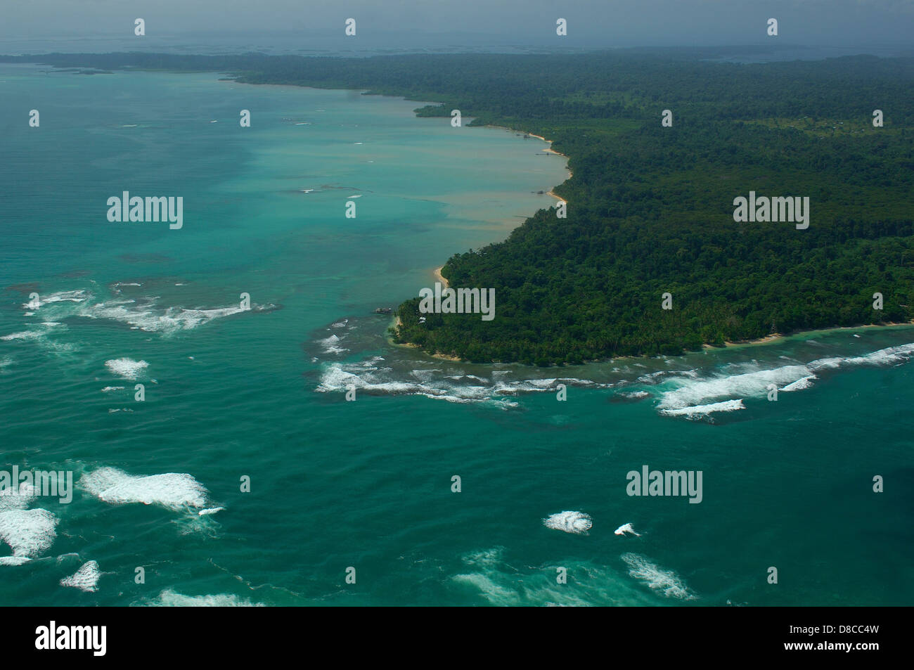 Aerial view of white waves coming to island shore Stock Photo
