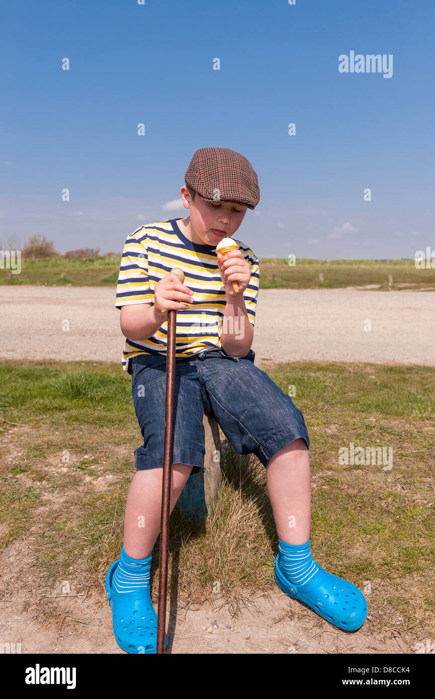 A 9 year old boy eating an ice cream in Walberswick , Suffolk , England , Britain , Uk Stock Photo