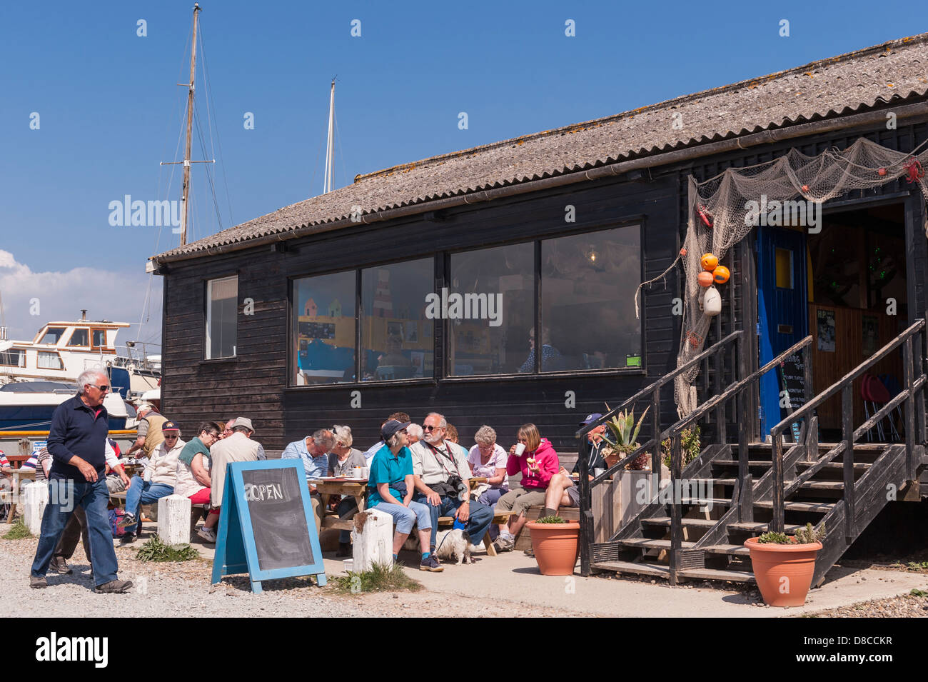 People having refreshments outside a cafe at the harbour in Southwold , Suffolk , England , Britain , Uk Stock Photo