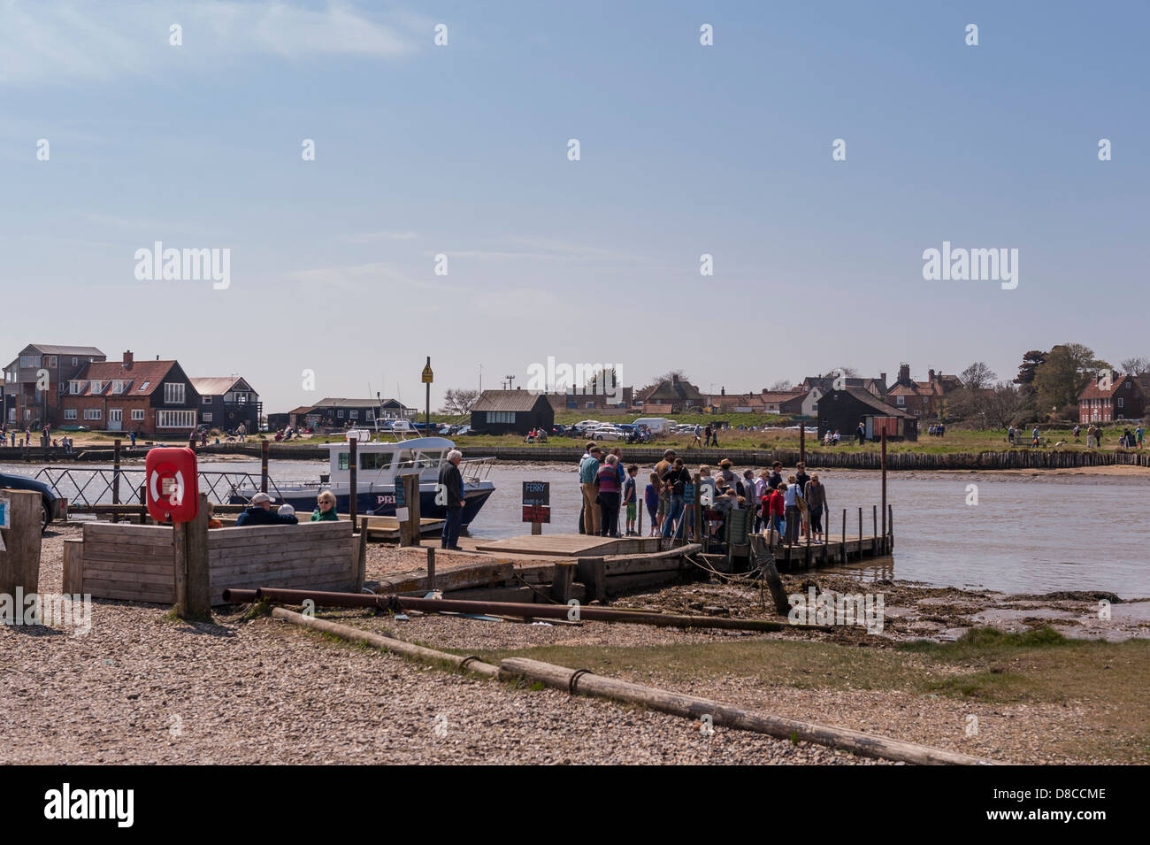 People queue to catch the ferry to Walberswick from Southwold , Suffolk ...