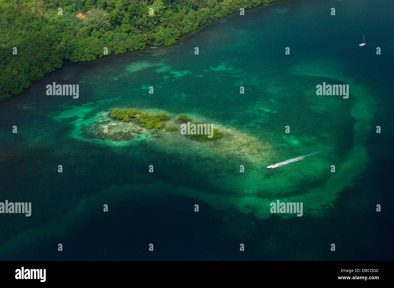Aerial view of motor boat navigating over reef near the shore Stock Photo