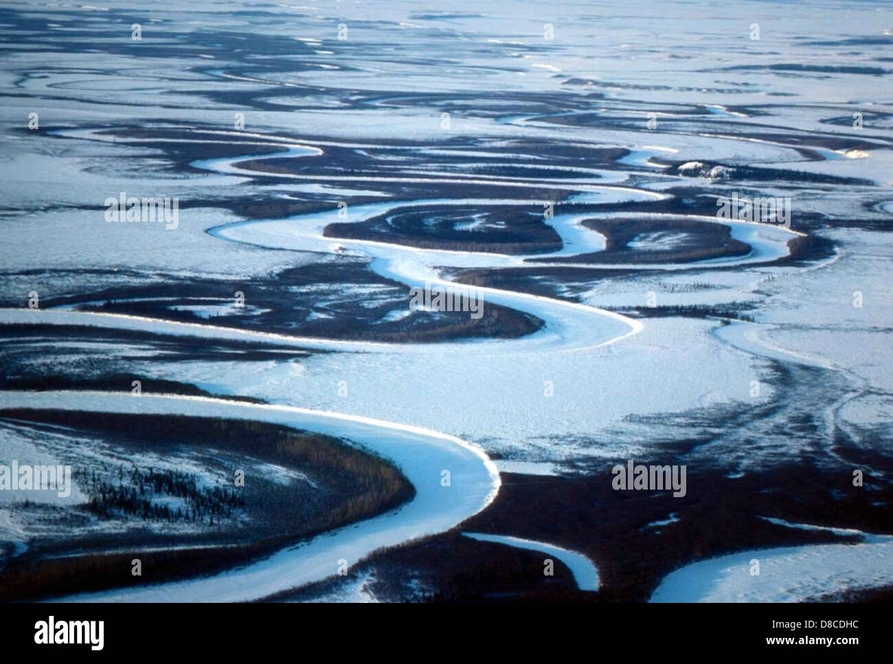 An aerial view of a frozen river during the winter season, showing the ...