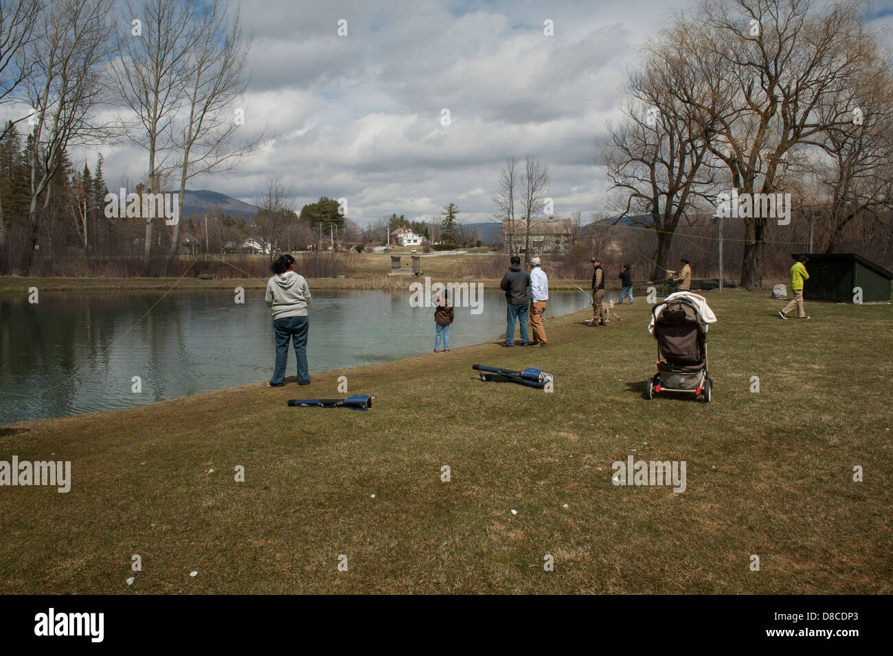 A family is taking fly fishing lessons at the Orvis trout pond in Manchester, Vermont. Stock Photo