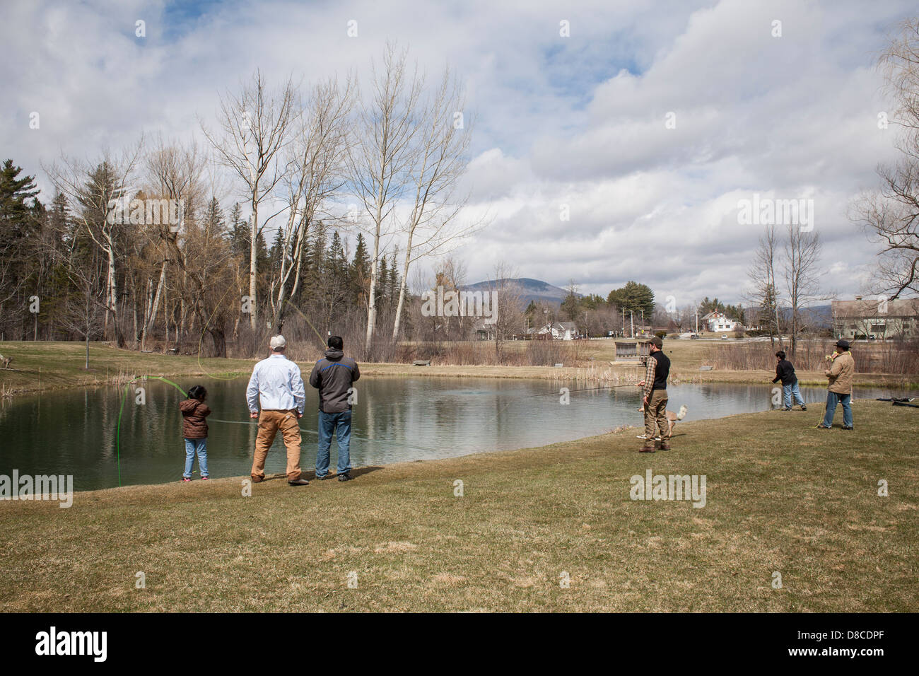 A man and his daughter are taking fly fishing lessons at the Orvis