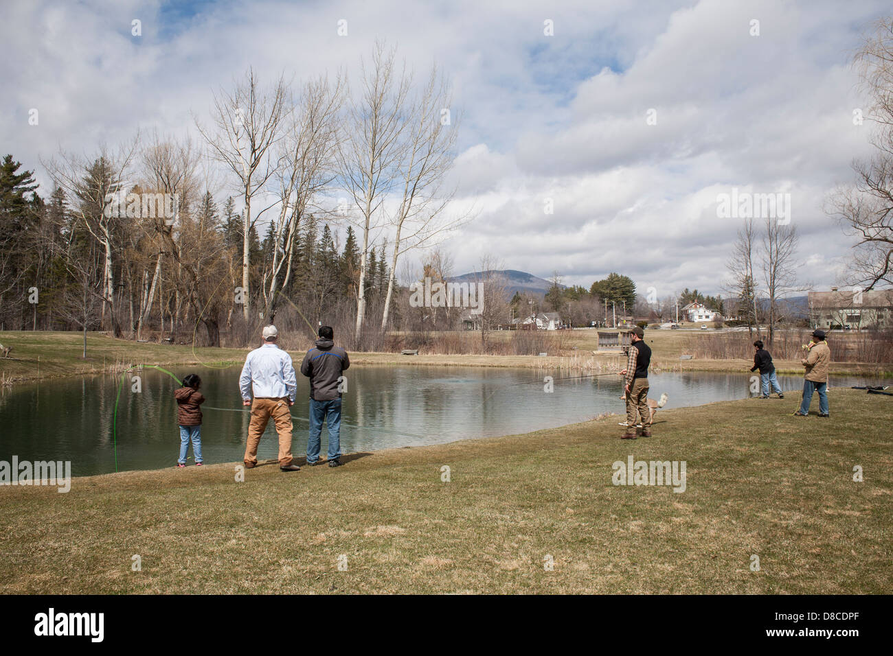 A man and his daughter are taking fly fishing lessons at the Orvis trout pond in Manchester, Vermont. Stock Photo