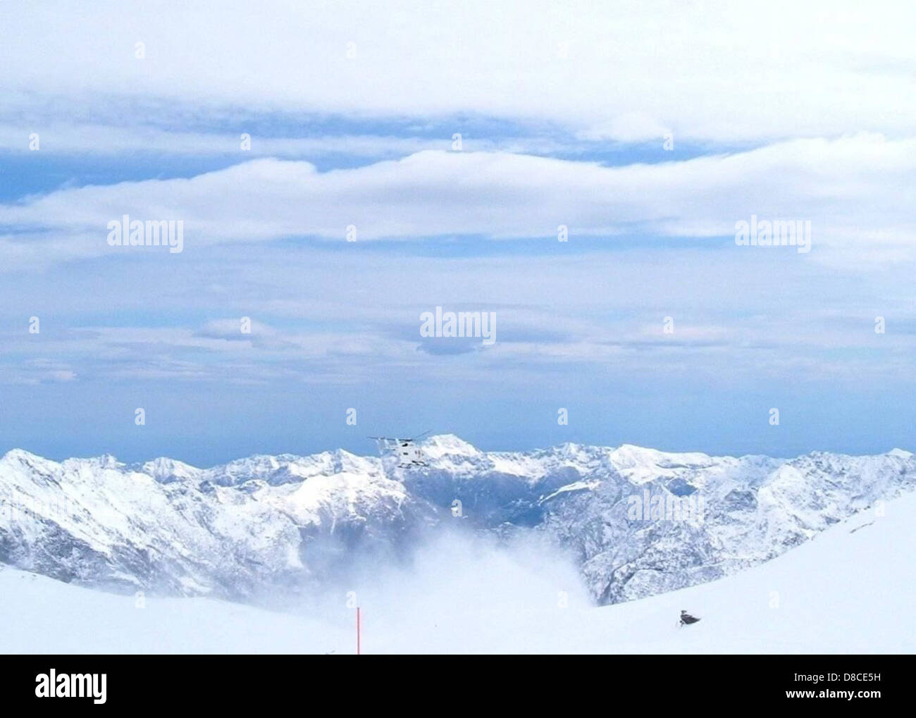 The stunning Alps mountains covered in snow under a clear blue sky. The ...