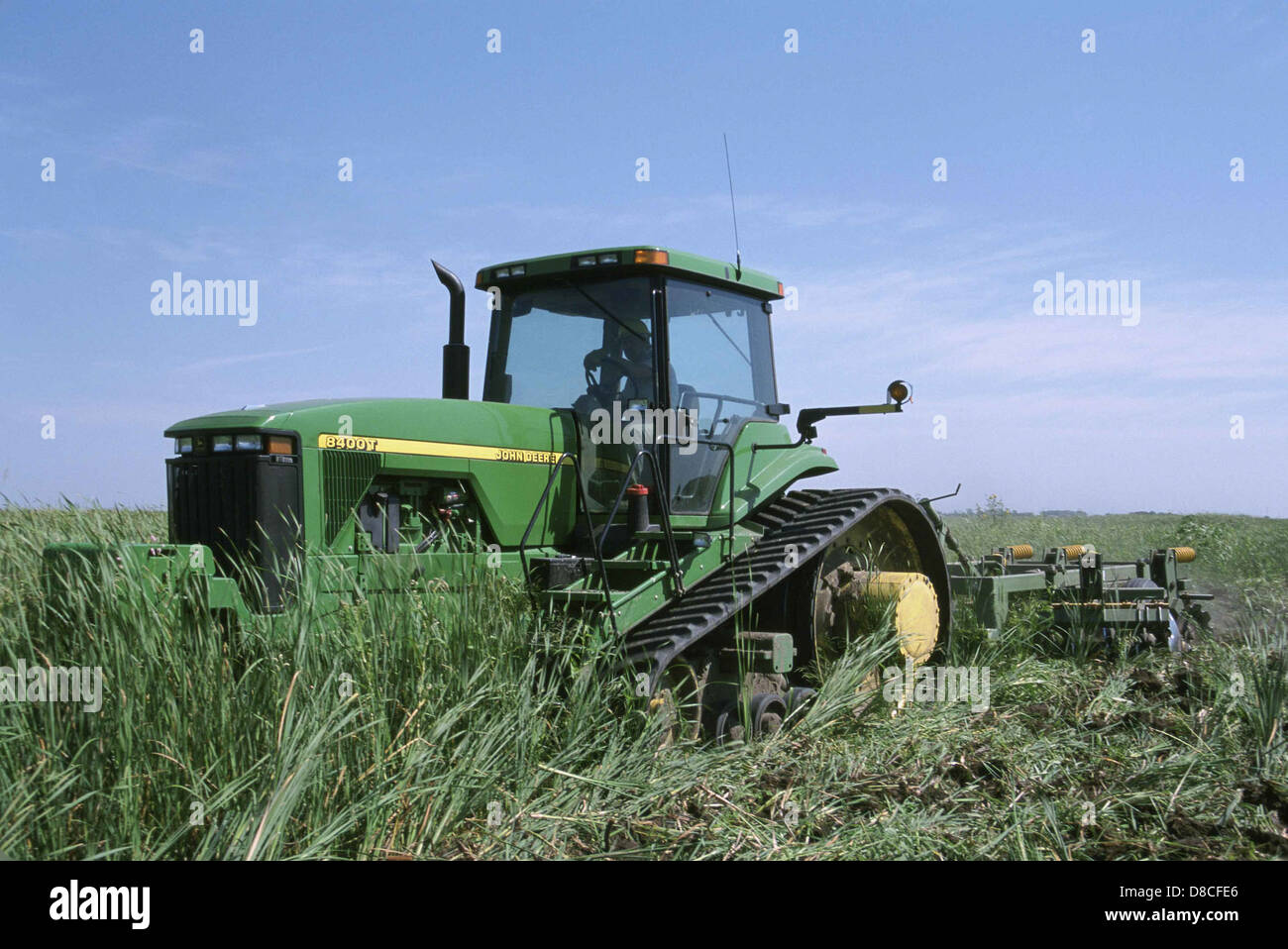 Big stron tractor wehicle working in grass. Stock Photo
