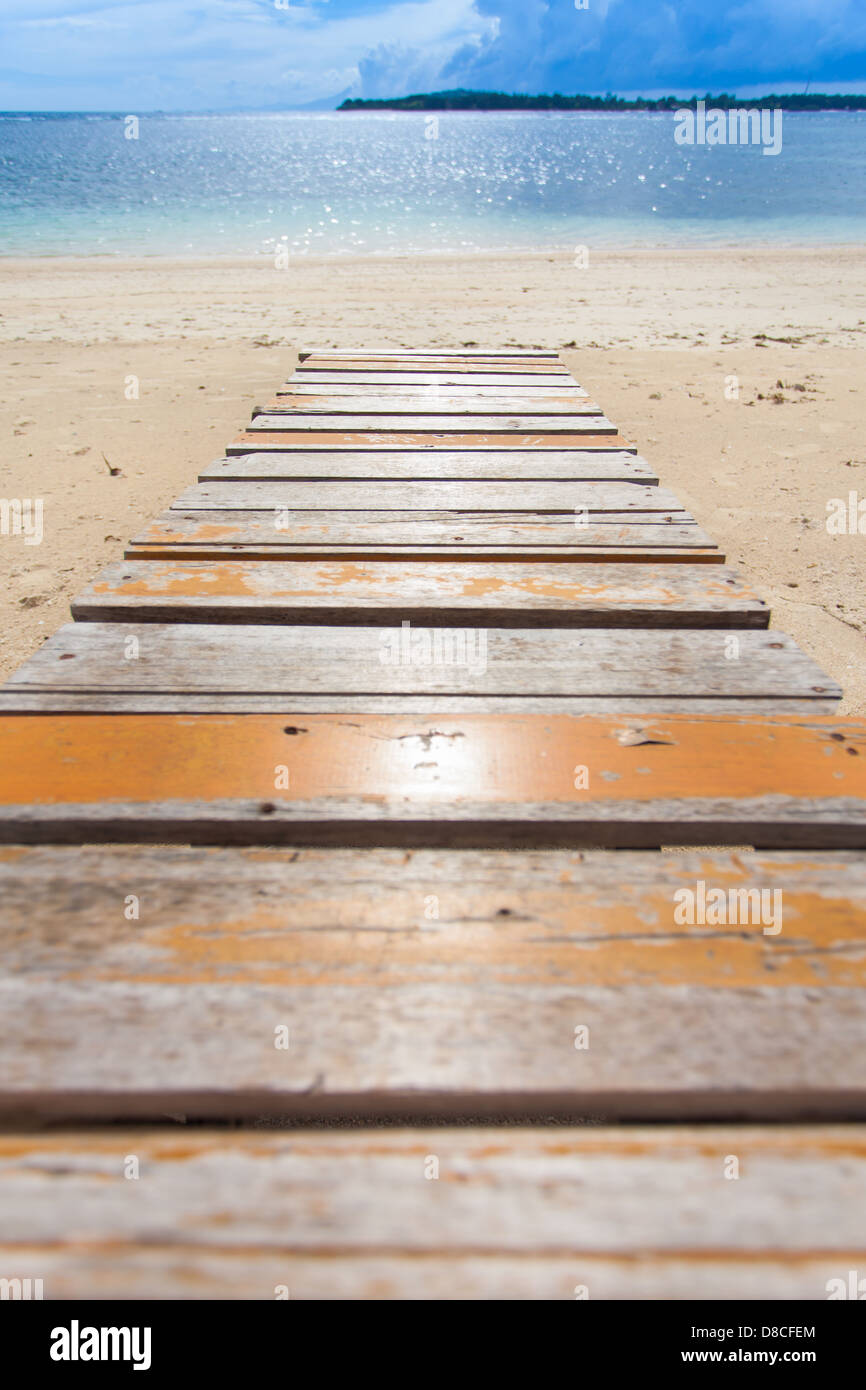 Wooden jetty on tropical beach on island Stock Photo - Alamy