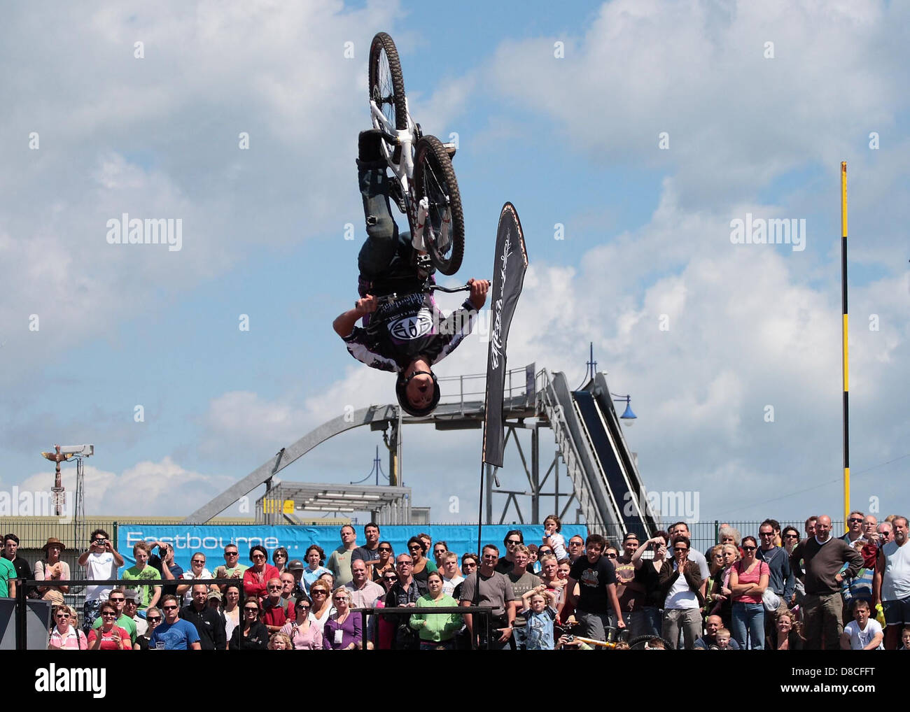 A biker performs a jump on a mountain bike, showcasing athleticism and ...