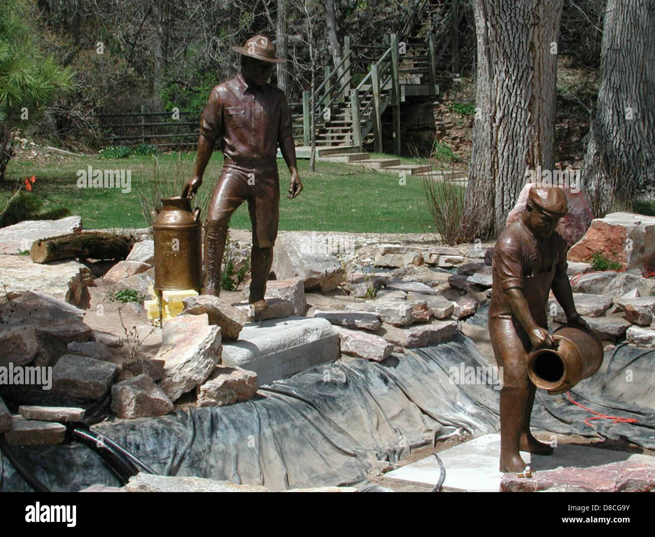 A detailed bronze sculpture depicting fishery workers in action ...