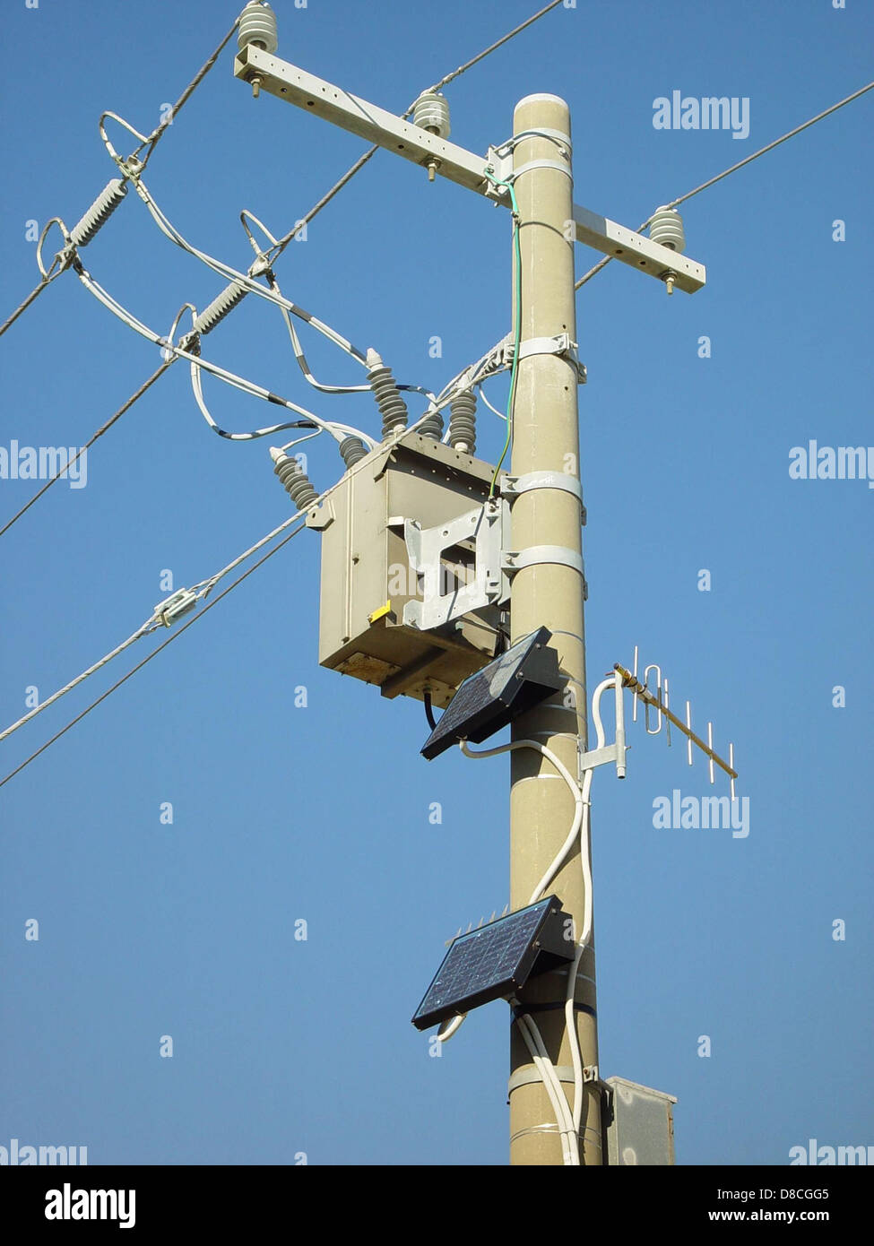 A power pole equipped with solar panels, indicating the integration of ...