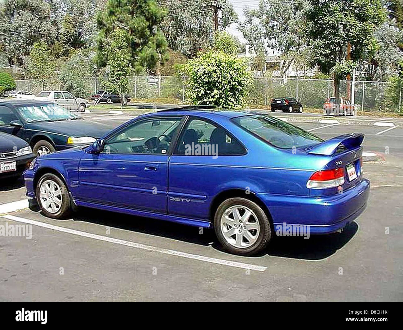 A Compact Car Specifically A Honda Civic Is Shown Parked In An Urban a-compact-car-specifically-a-honda-civic-is-shown-parked-in-an-urban