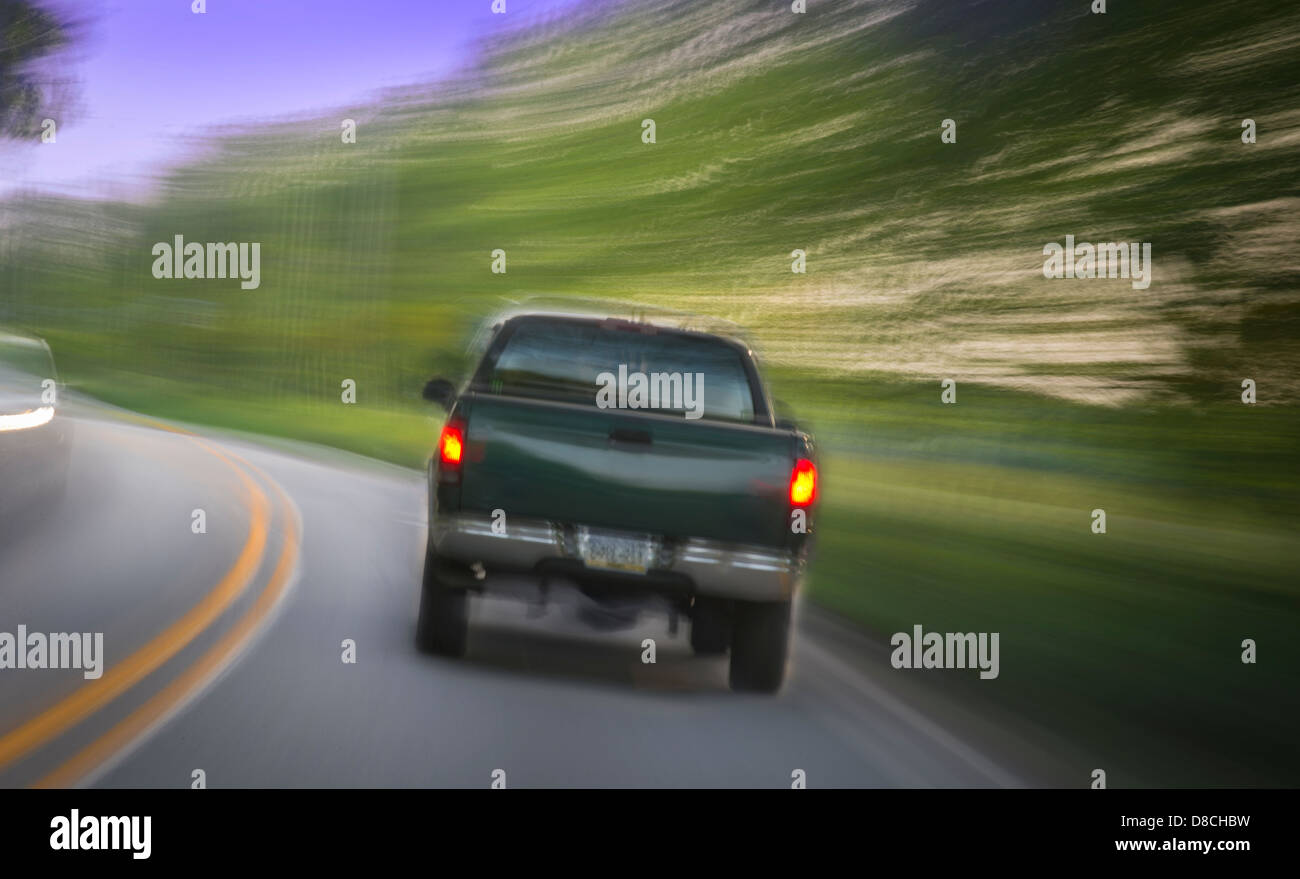 PickUp Truck On Road   During The Day With Motion Blur Stock Photo