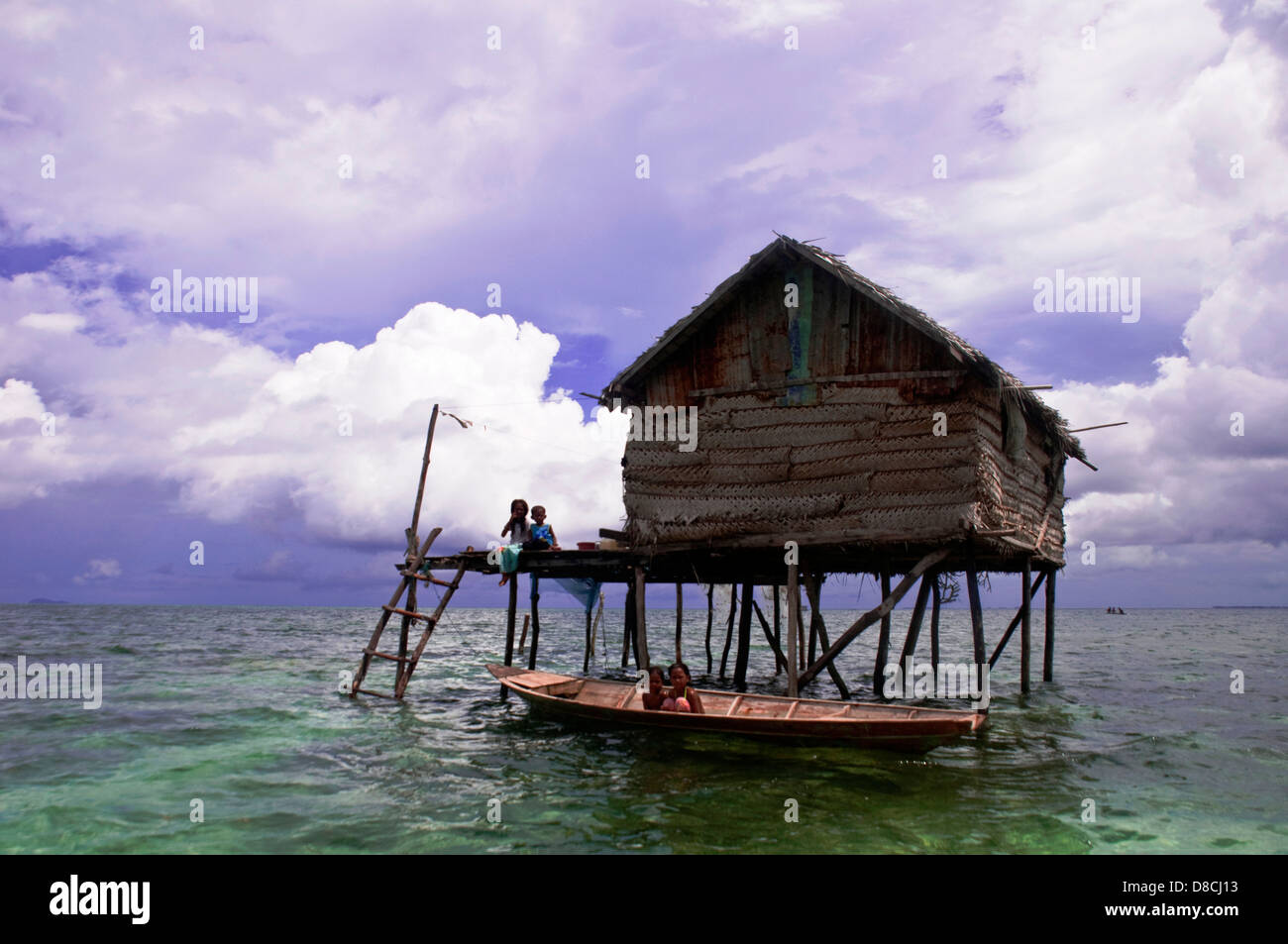 the family members outside their floating house in Semporna Island in Sabah on Apr 22 2013 Stock Photo