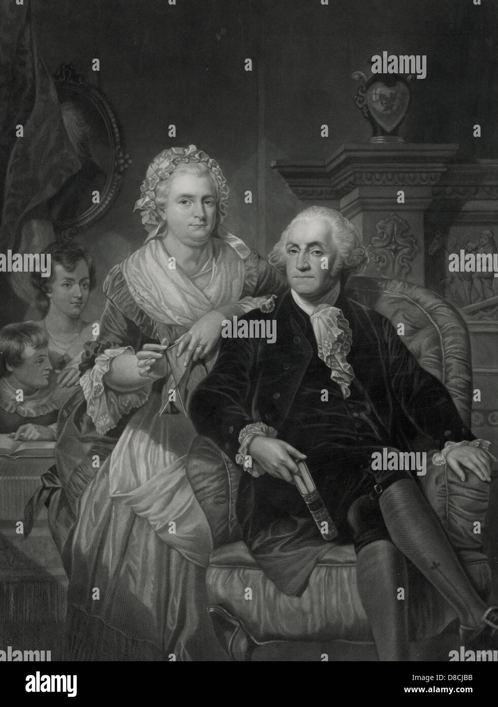 George Washimgton at home - George Washington, full-length portrait, sitting in a chair, facing front, holding a book, with Martha Washington next to the chair on the left. In the background, on the left, are two children and on the wall behind them is a portrait painting with the face obscured by a curtain. Stock Photo