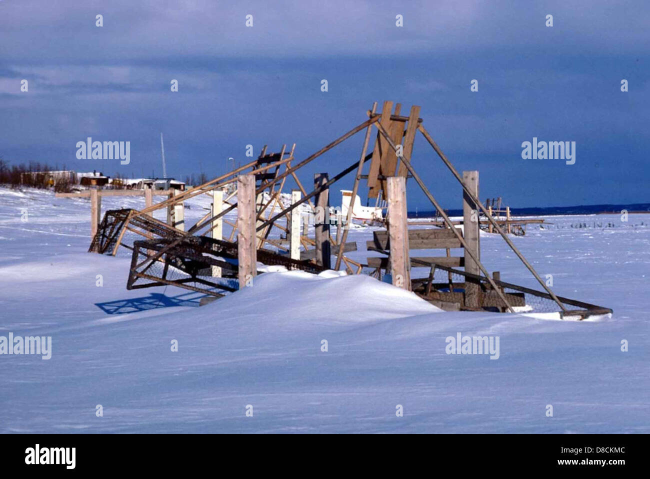 A traditional fish wheel is seen in the snow-covered landscape. Fish ...
