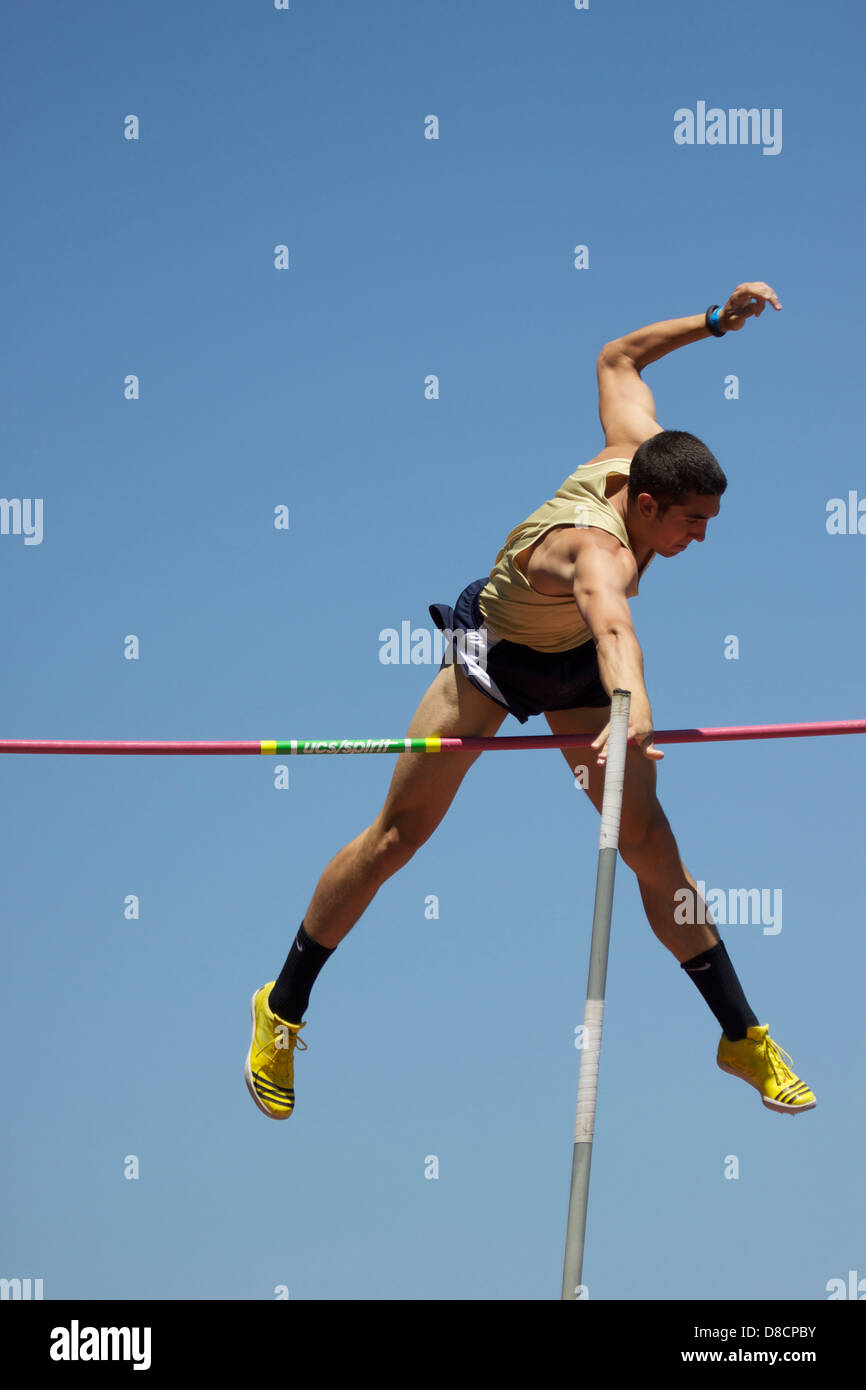 Pole Vaulter clears the pole vault bar during a track and field meet Stock Photo Alamy