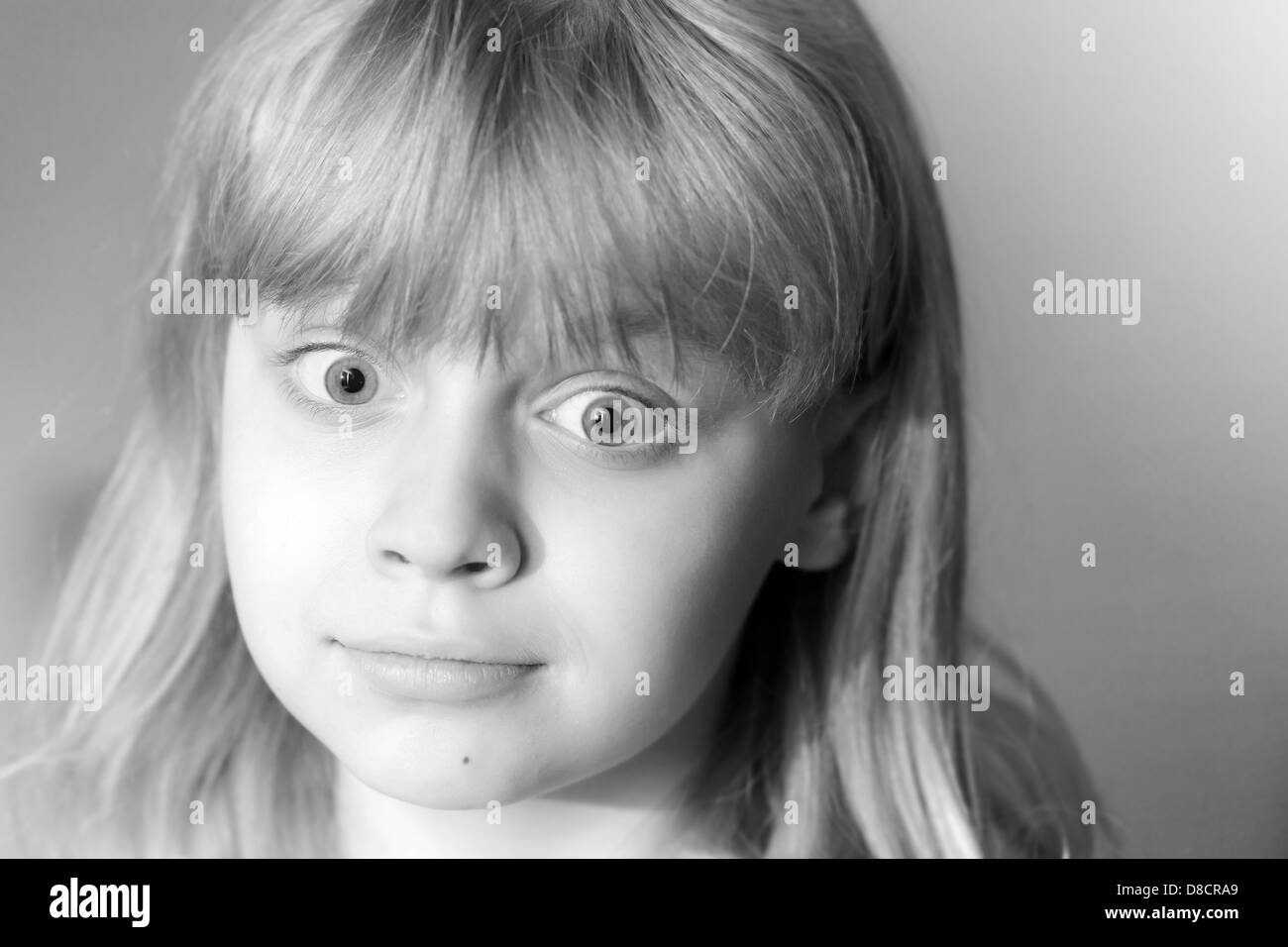 Monochrome portrait of confused little blond girl Stock Photo