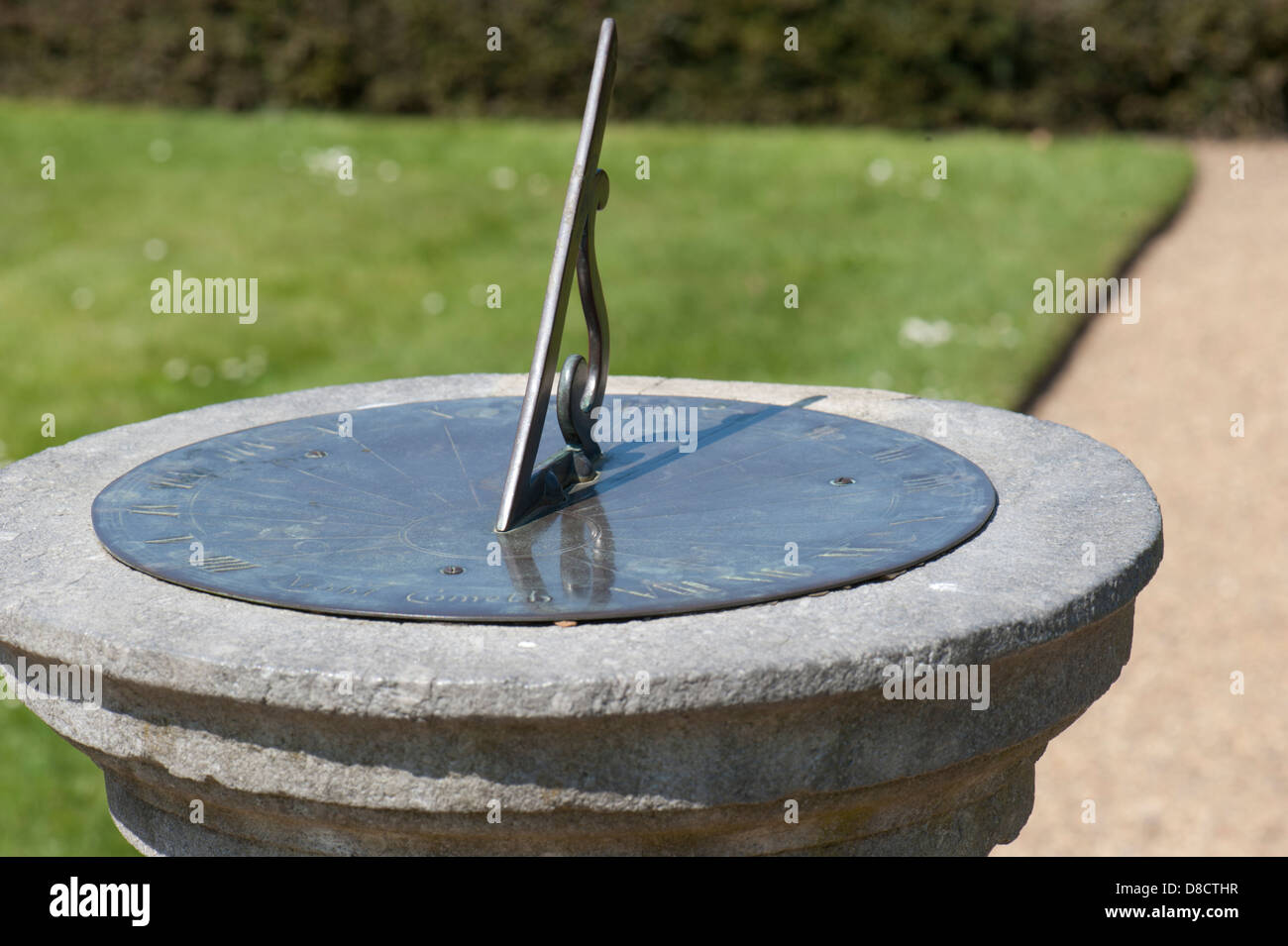 Horizontal sundial, set on a pedestal in a West Sussex garden, UK Stock