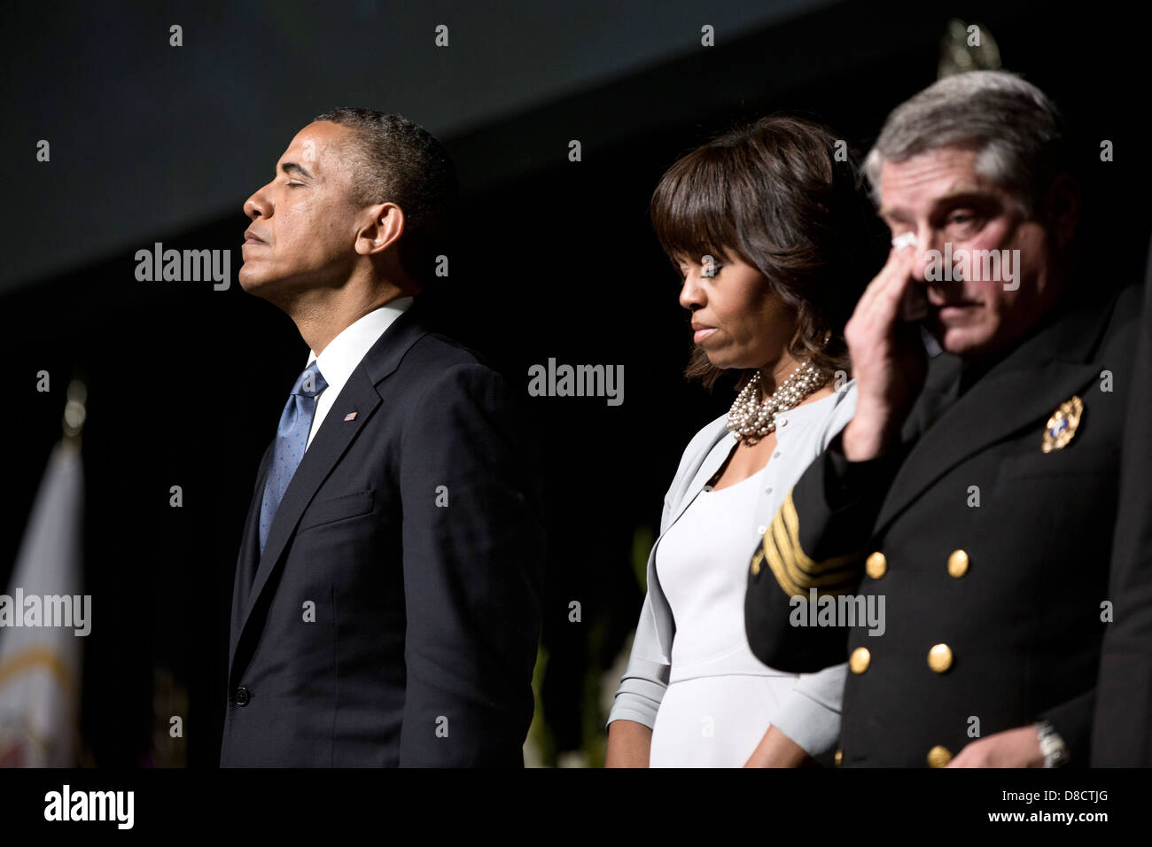 US President Barack Obama and First Lady Michelle Obama pause during a memorial service for victims of a fertilizer plant explosion in West, Texas, at Baylor University April 25, 2013 in Waco, Texas. Fire Chaplain Jimmy Duncan stands with the President and Mrs. Obama. Stock Photo