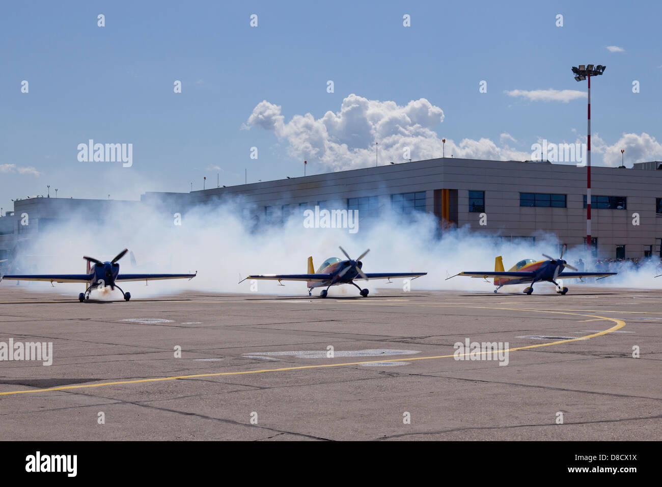 airplanes on the ground making a lot of smoke before taking off Stock Photo