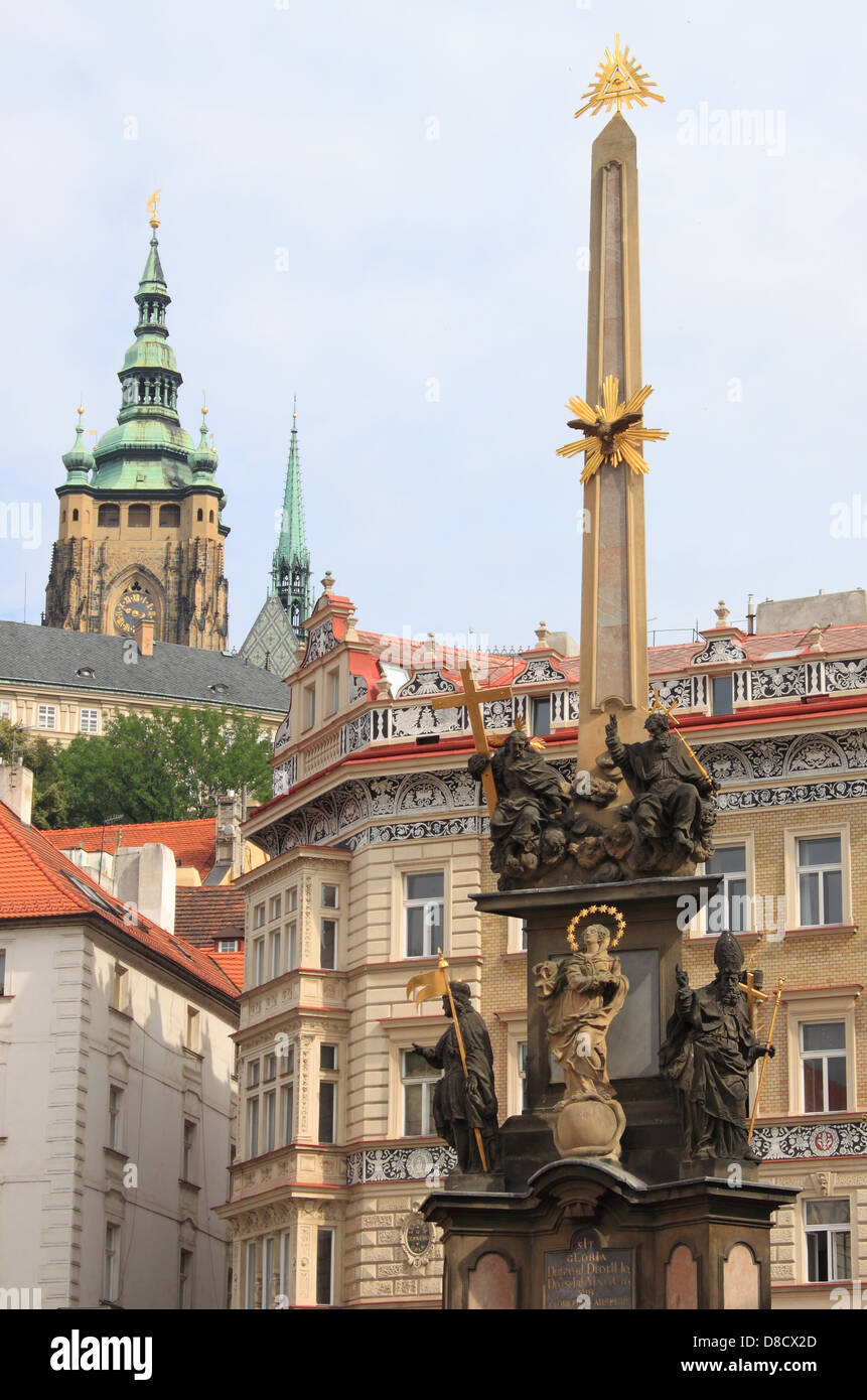 Urban scenic of Prague with baroque column of Holy Trinity in front of St. Nicolas Church at Lesser Town Square Stock Photo