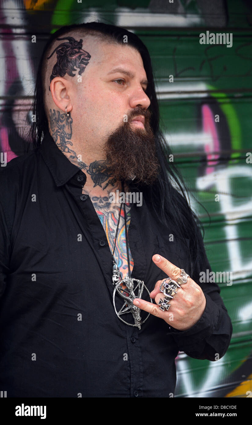 Man with multiple tattoos and rings and a half shaved head. In Greenwich Village New York City. Stock Photo