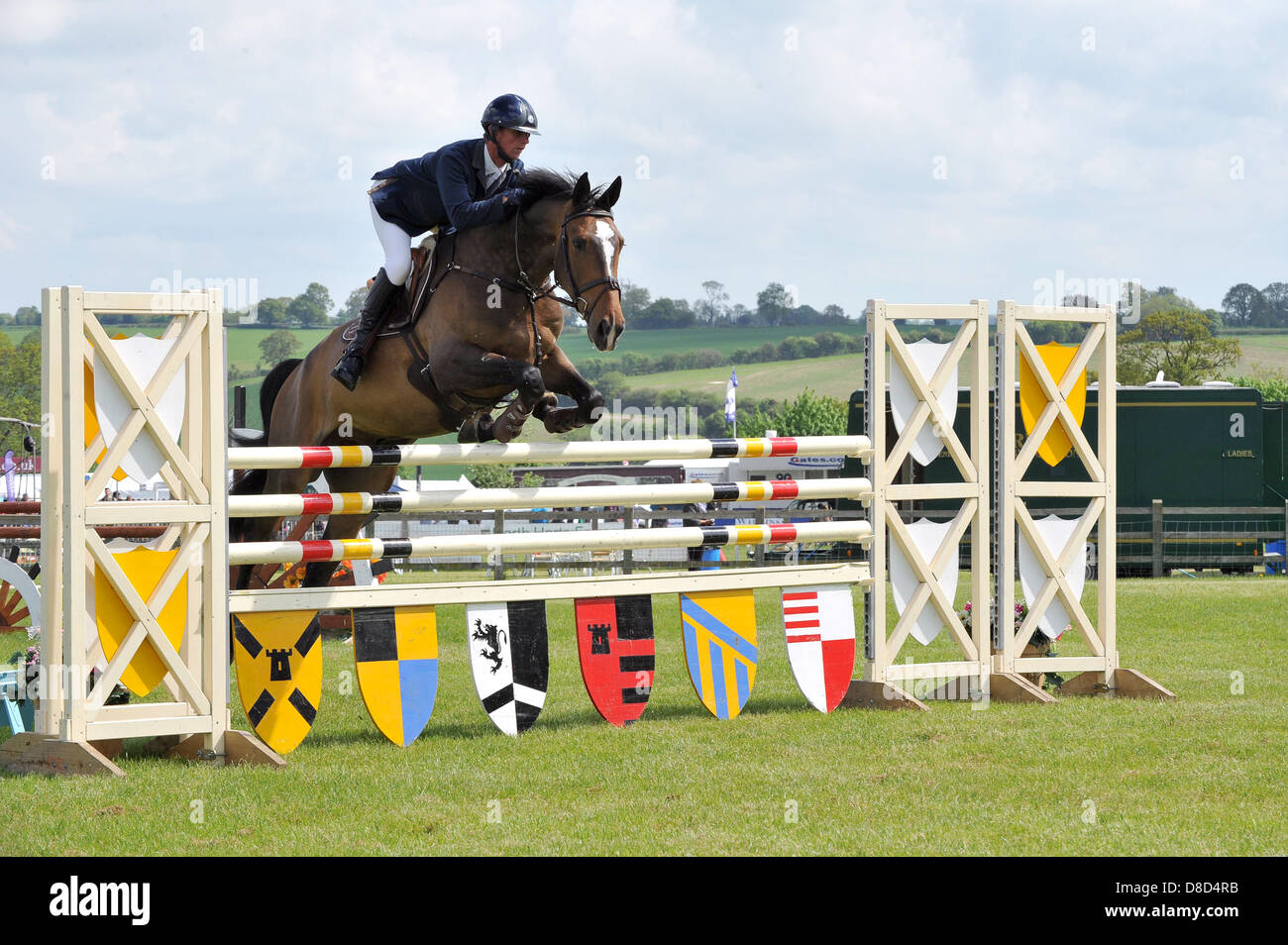 REDBOURN, UK. 25th May 2013. Show jumping at the Hertfordshire County Show. Phillip Miller rides Di and Pennie Cornish' horse Quizmaster II in the Foxhunter 1.20m Open class. Stock Photo