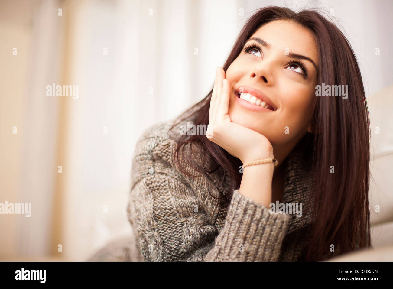 Closeup portrait of a Happy young beautiful woman relaxing at home ...