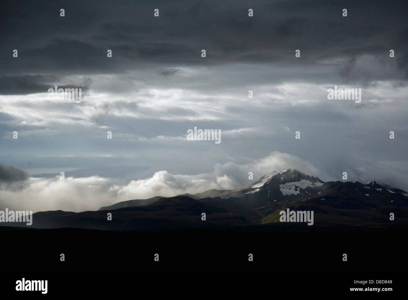 A breathtaking scenic view of a mountain range, with fluffy clouds in ...