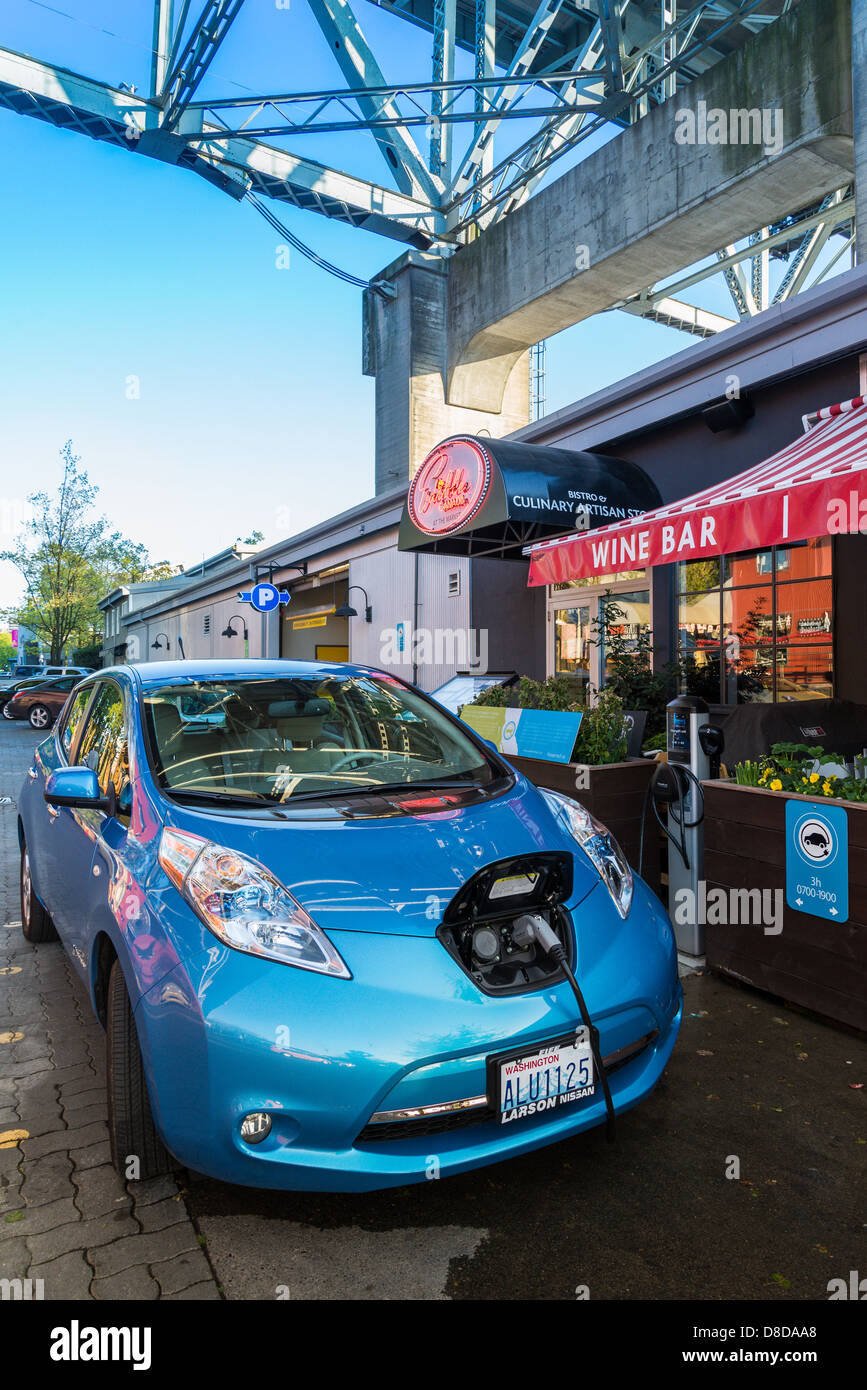 Nissan Electric car at plug in parking stall, Granville Island, Vancouver, British Columbia, Canada Stock Photo