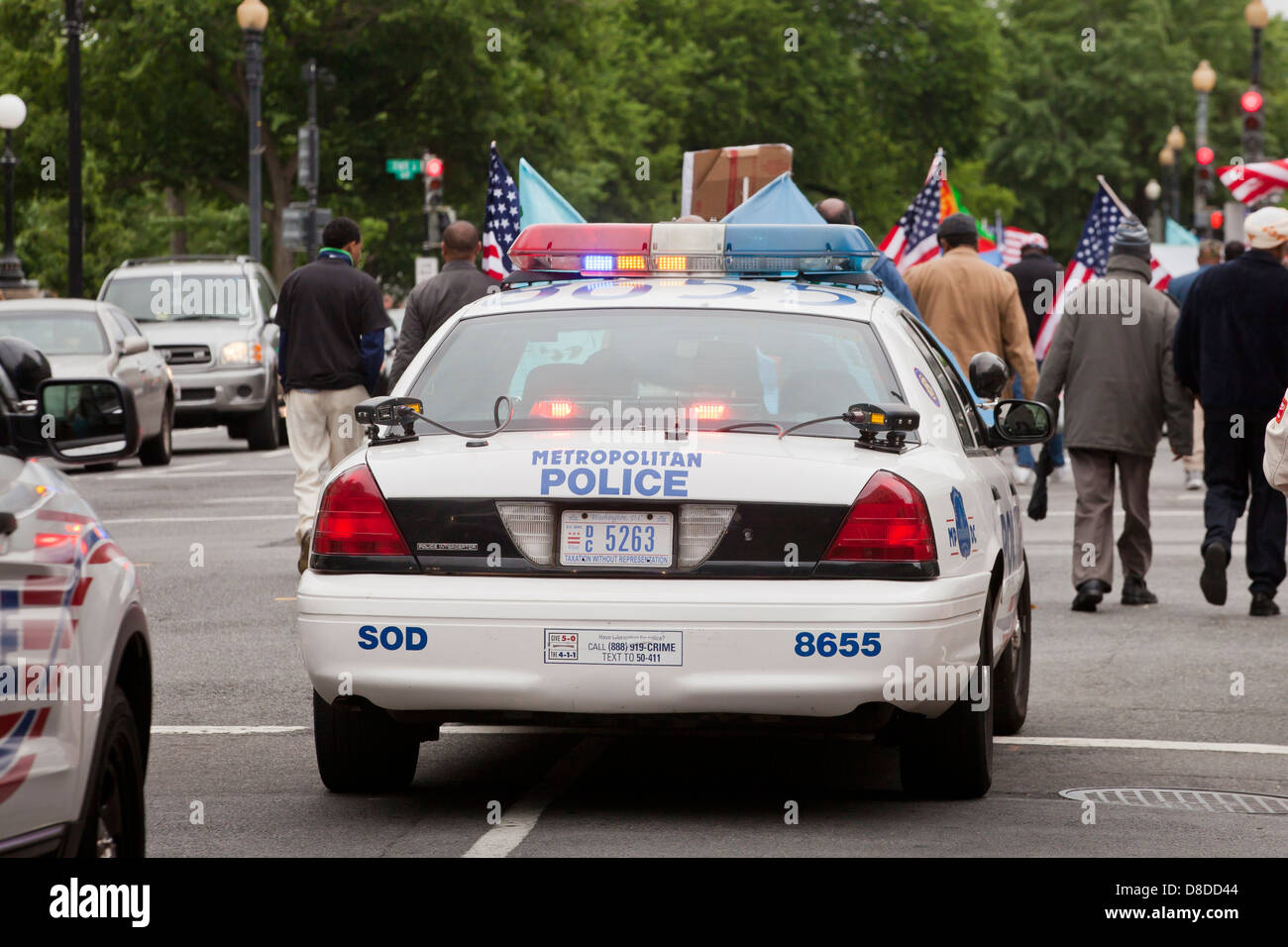 Police cars following demonstrators - Washington, DC USA Stock Photo